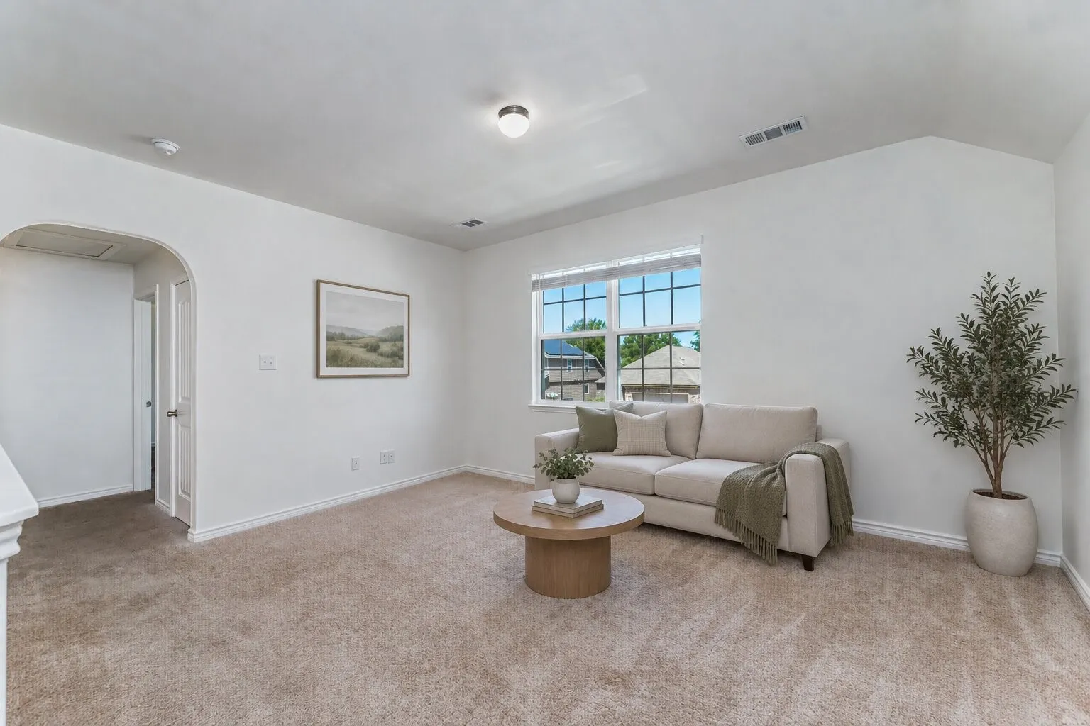 *virtually staged* Vaulted ceilings, archway, window with blinds, recessed lighting, and neutral carpeting