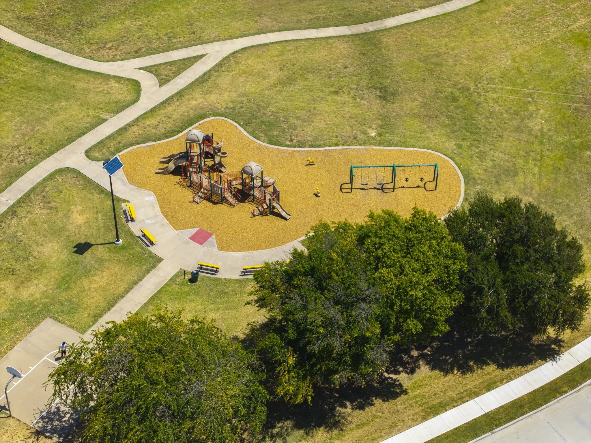 Community playground featuring swings and play structures