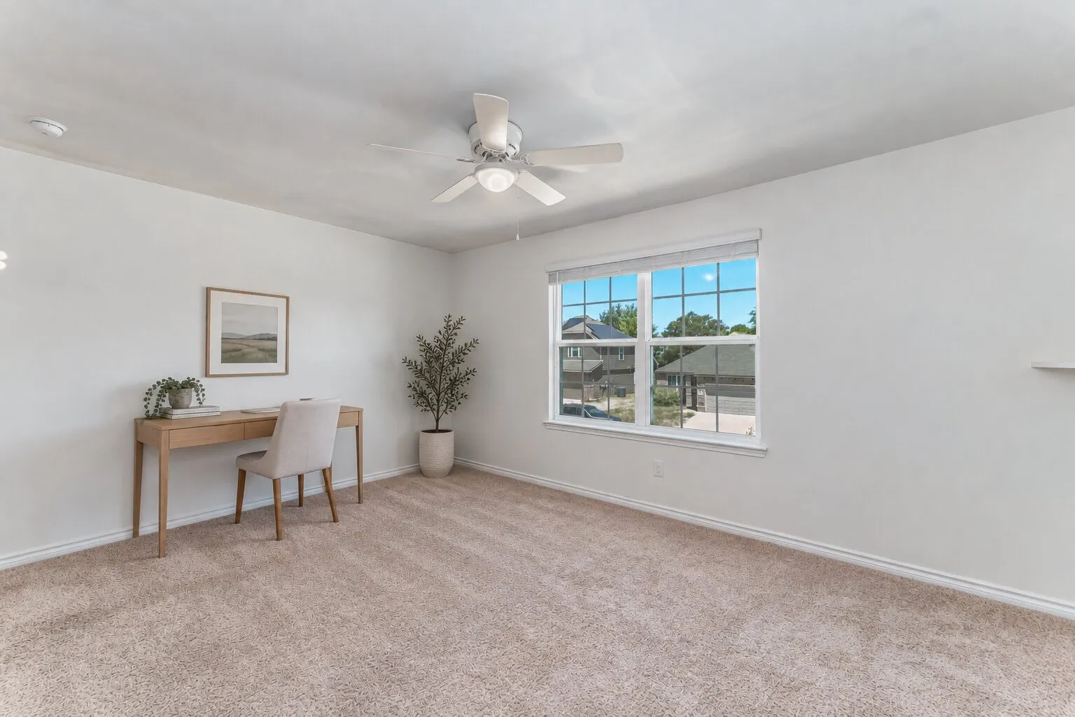 *virtually staged* Carpeted room with a ceiling fan, a window with muntins, and a built-in wall shelf
