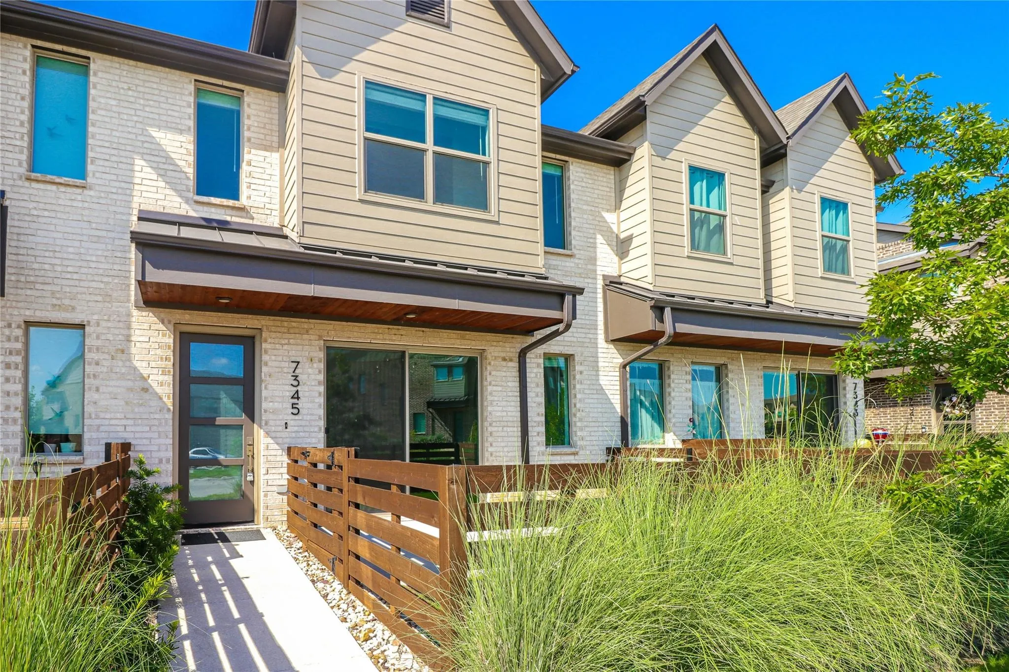 View of front of home featuring a fenced front yard and brick siding
