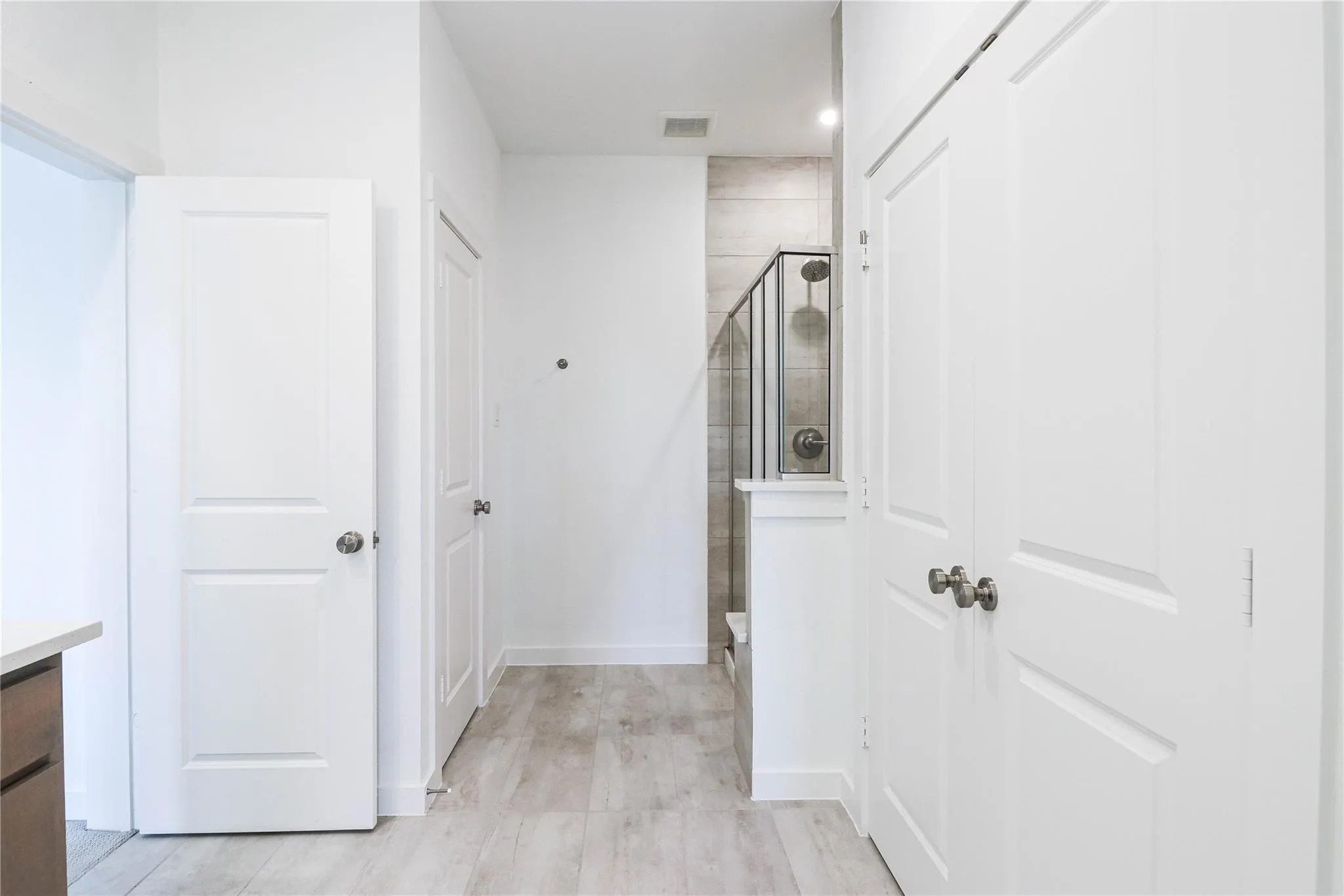Hallway with baseboards and light wood-style floors