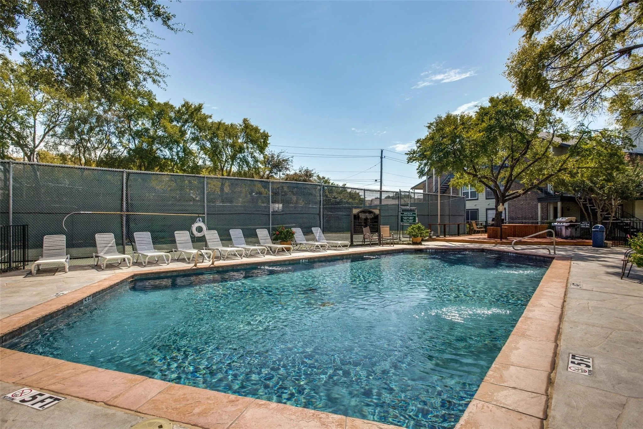 Rectangular swimming pool with a tile surround and integrated steps