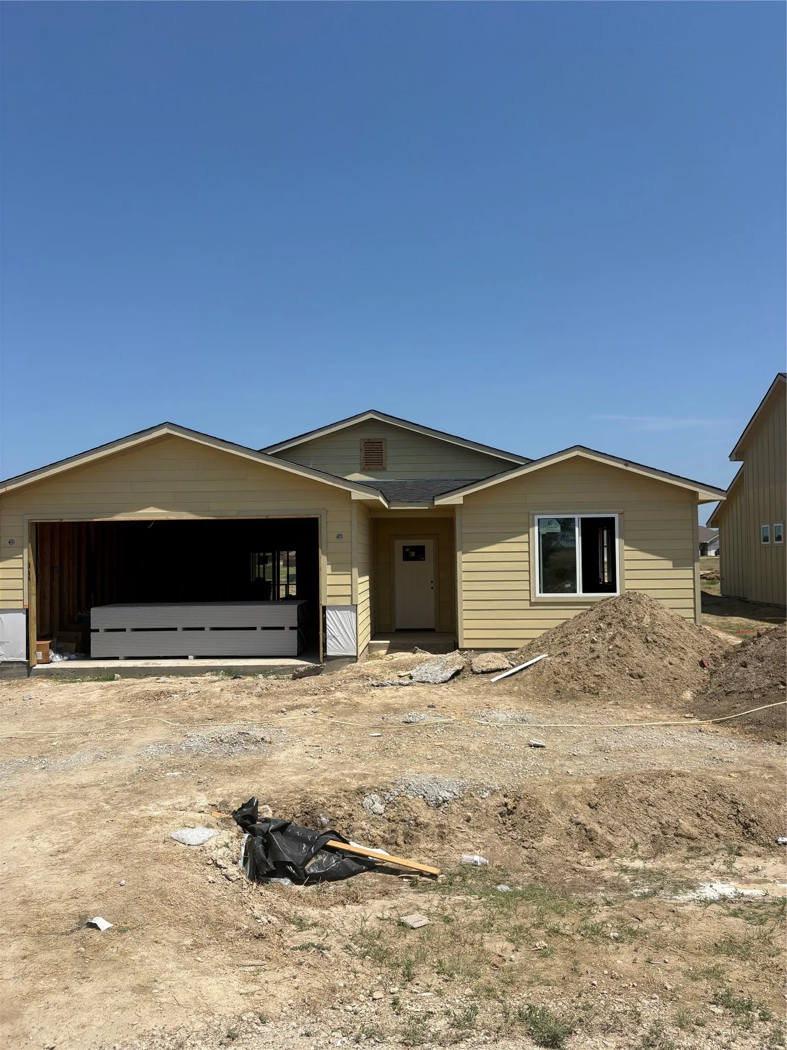 Gable rooflines over a light-colored exterior with horizontal siding