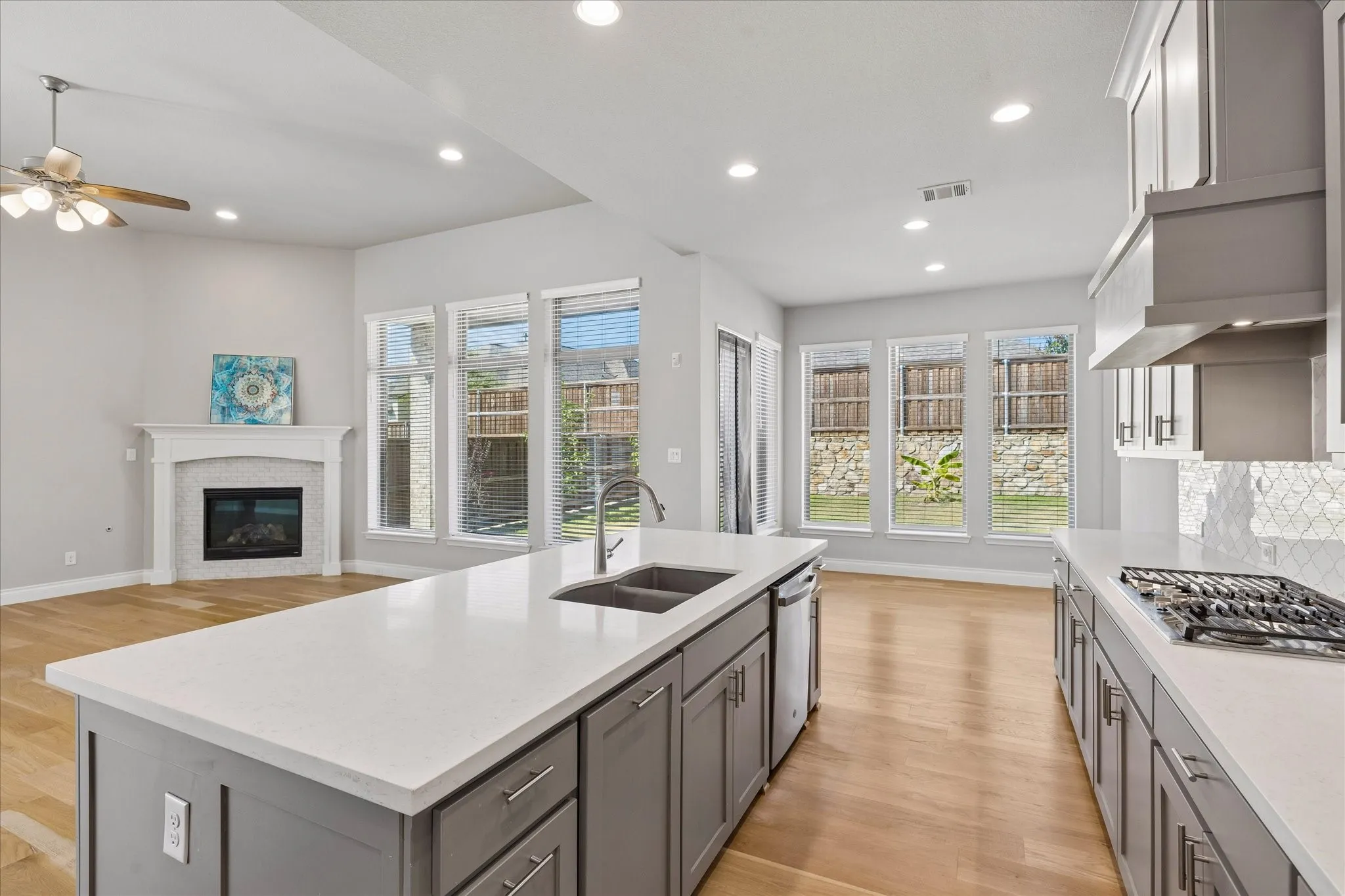 Open concept floor plan with kitchen, breakfast and living rooms with views to back porch and yard