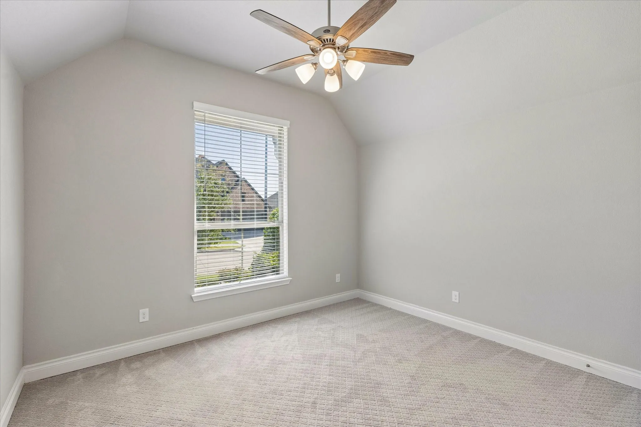 Front bedroom with walk-in closet and window with view of front yard