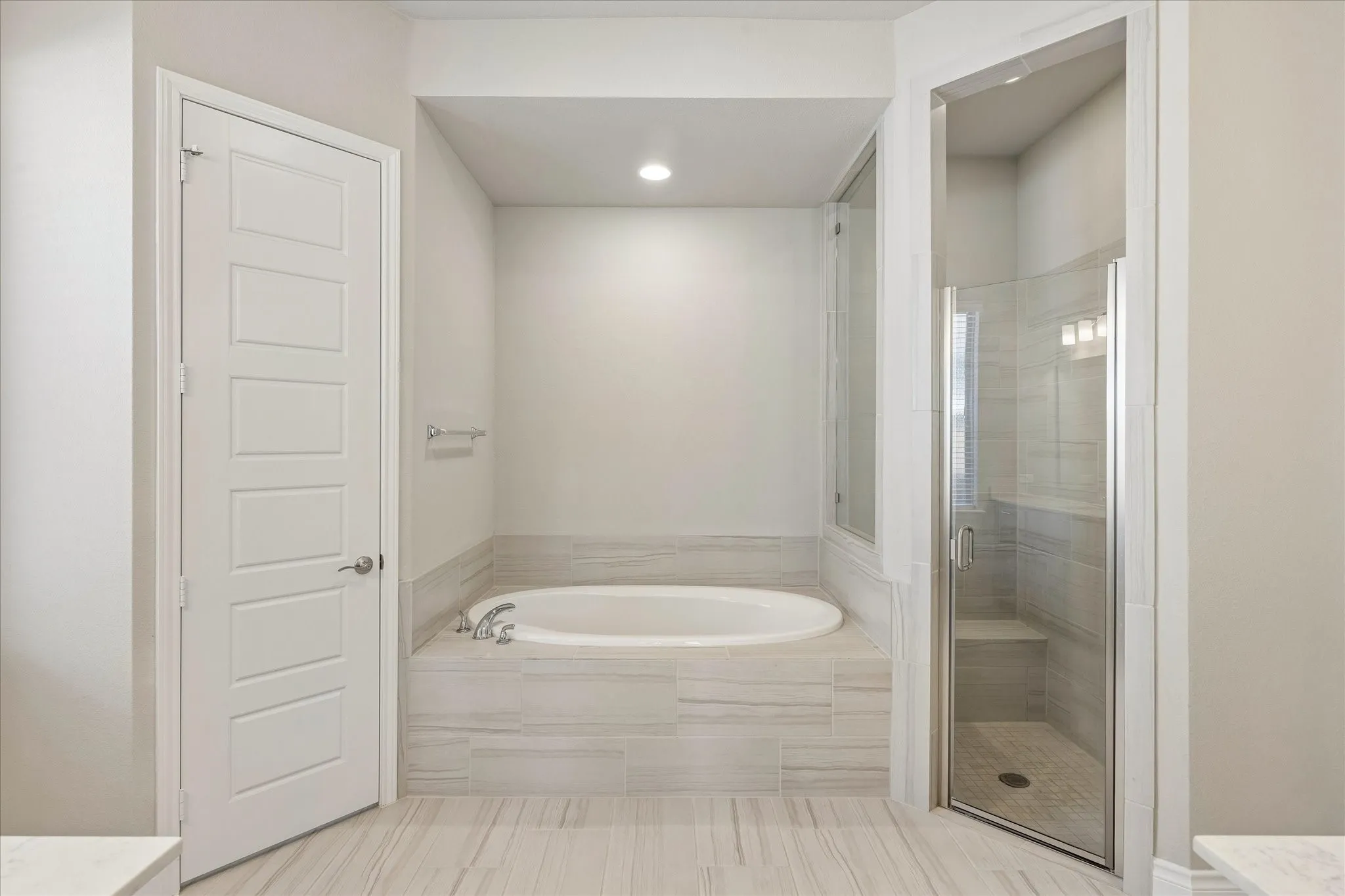 Primary bathroom with toilet in a separate room, garden tub, and walk-in shower with bench