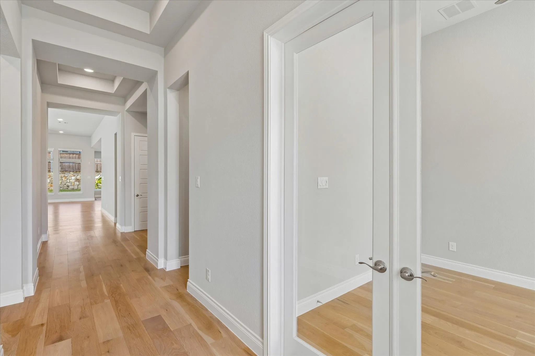 Entrance hall from front door and home office with glass French doors