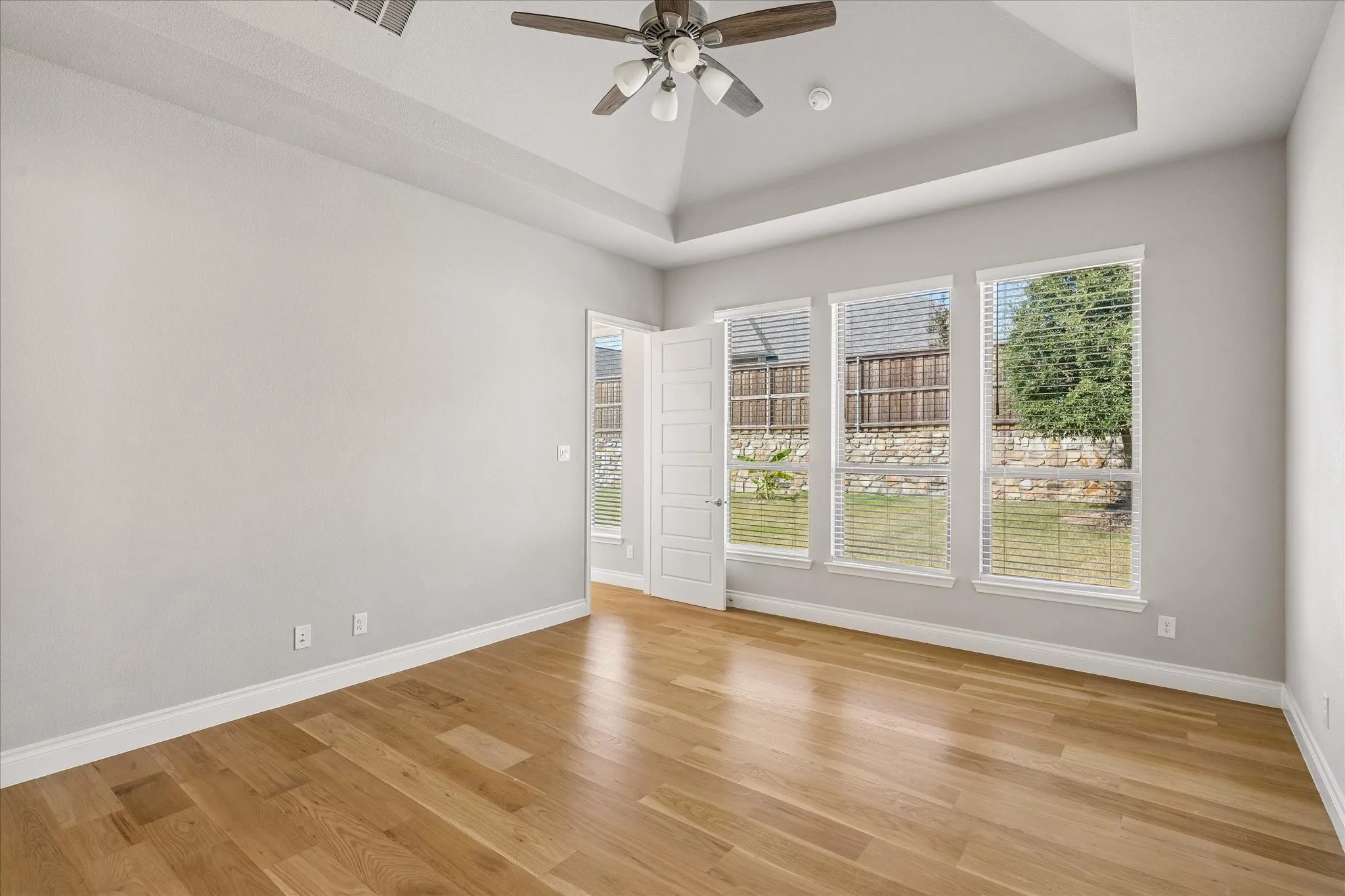 Primary bedroom with vaulted ceiling