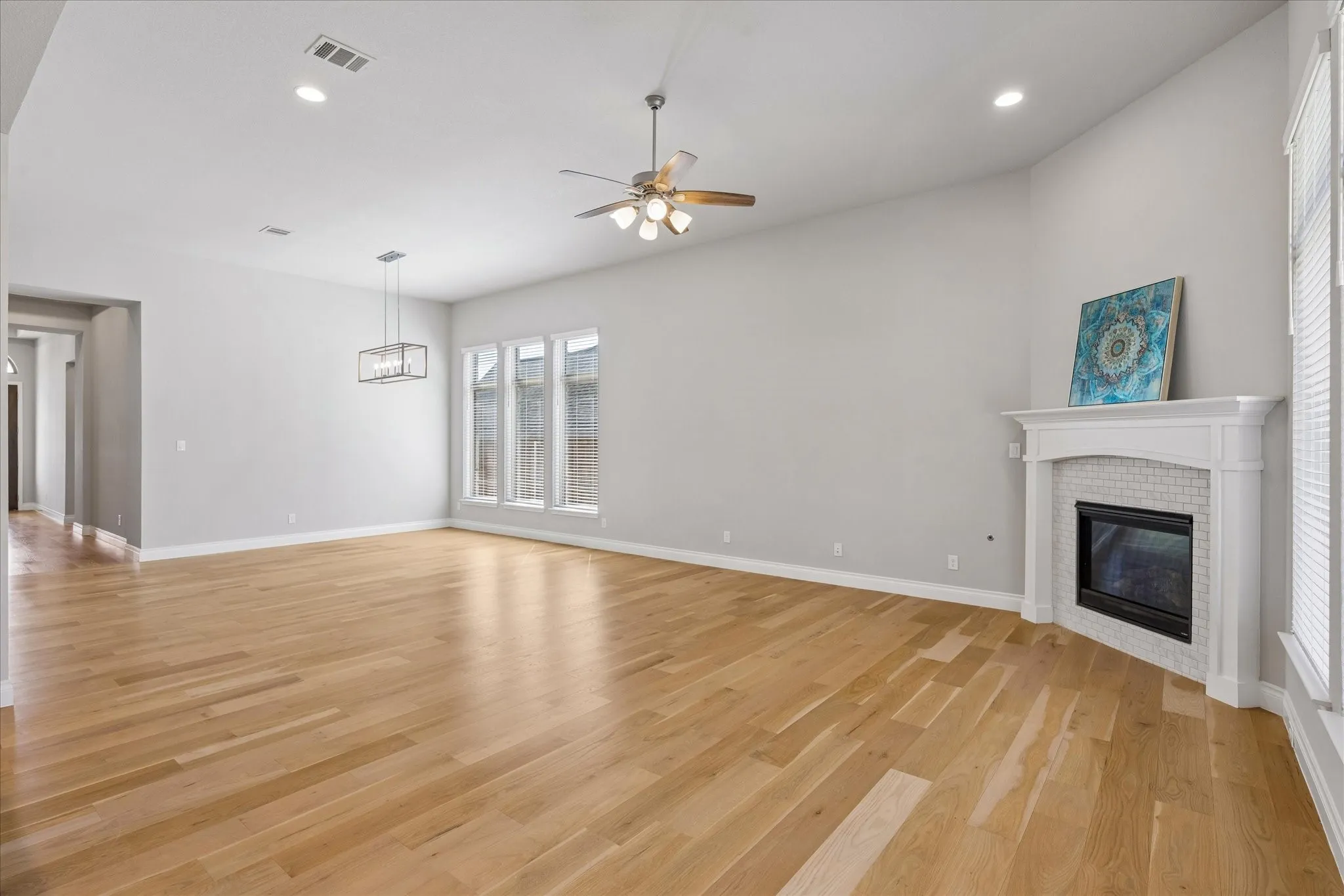 Open concept floor plan showing living with fireplace and dining room
