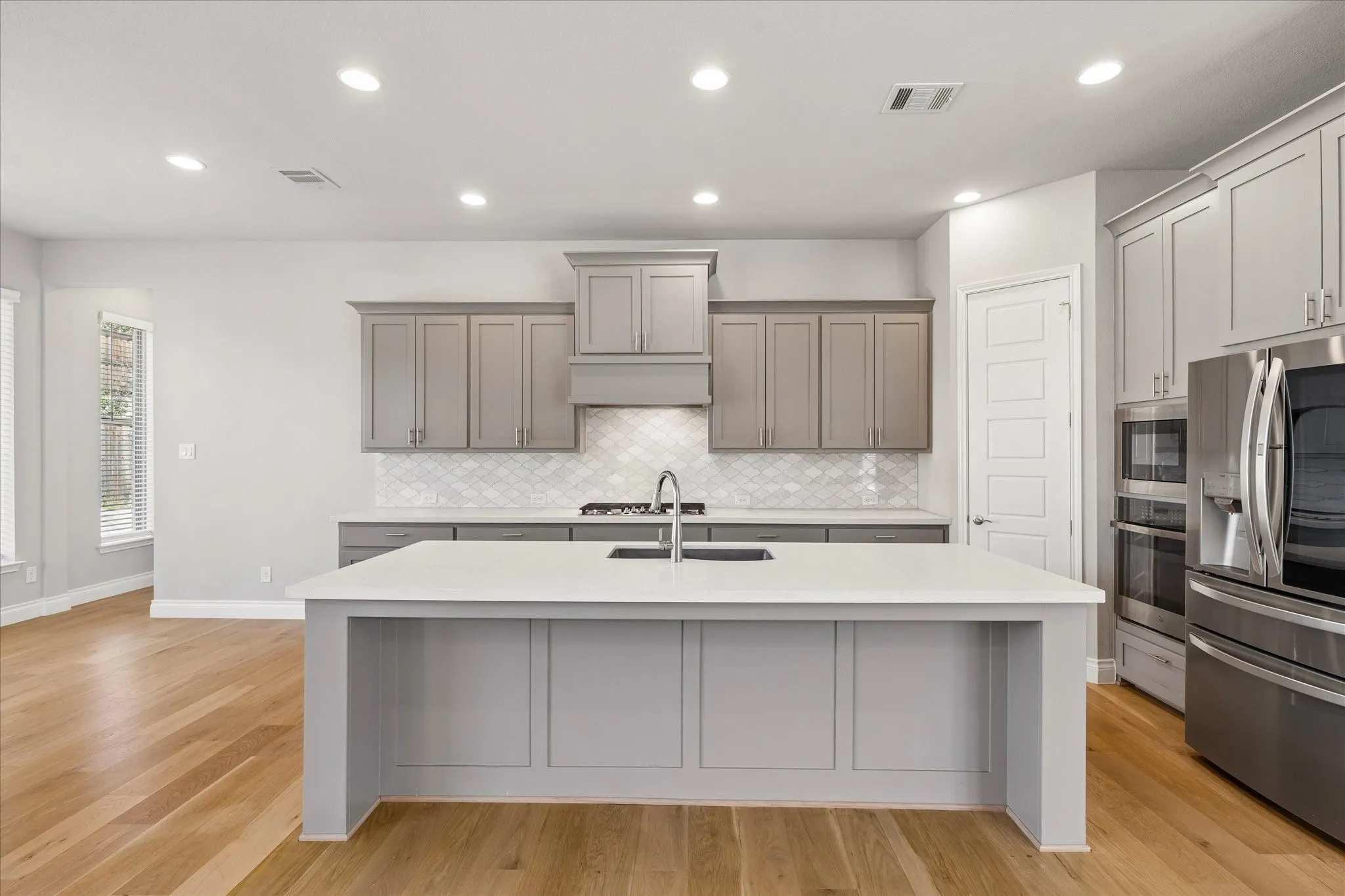 Kitchen with island with bar seating and walk-in pantry