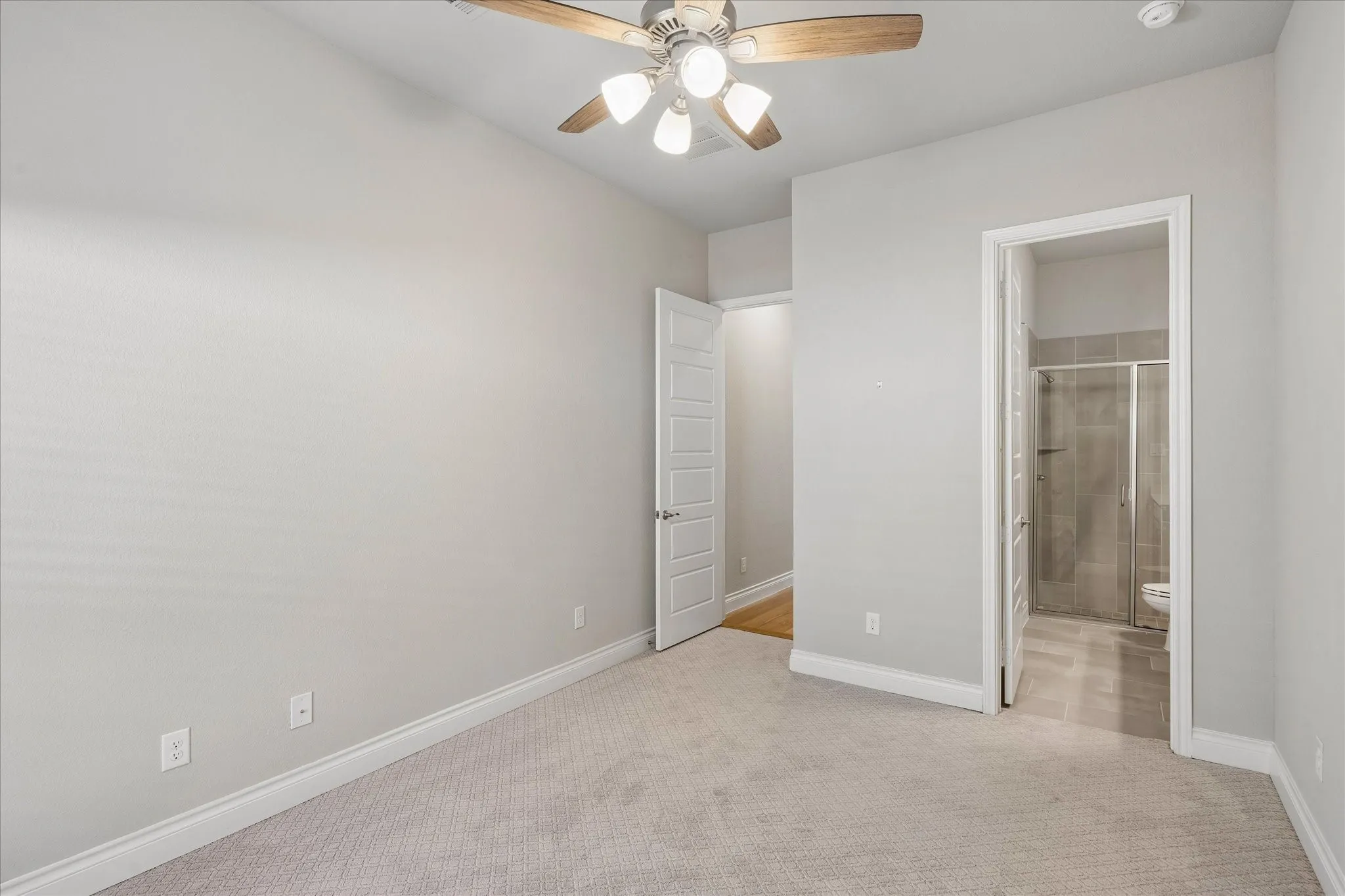 Bedroom suite with bathroom with walk-in shower and closet