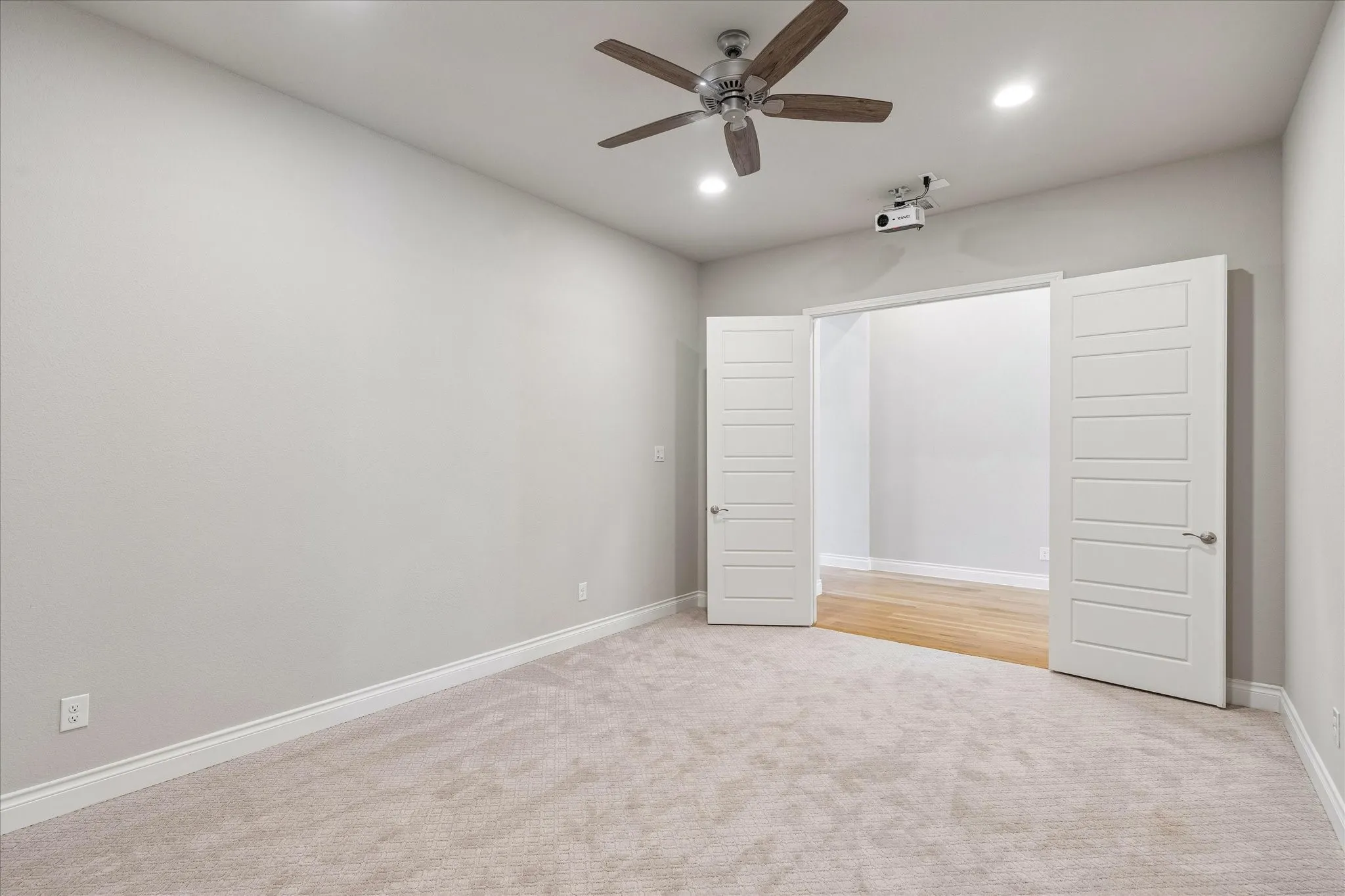 Media room with French doors and projection equipment installed