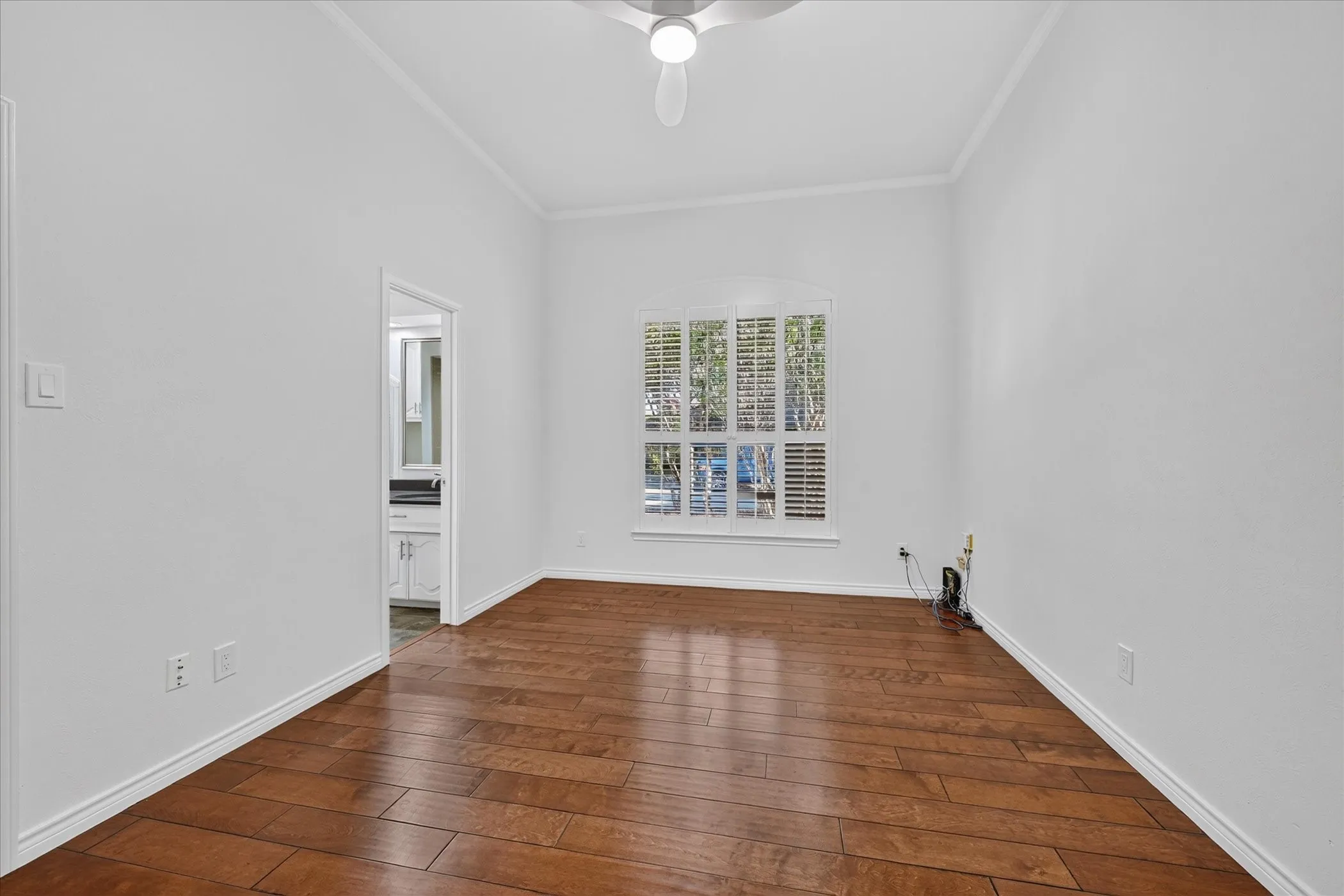  shutters wood-finish flooring ceiling fan large closet