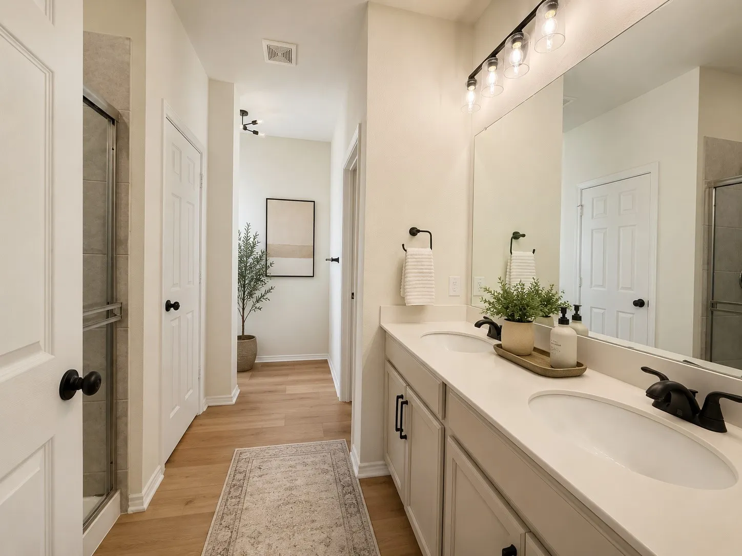Dual vanity with integrated sinks, light-toned countertop, and matte black fixtures