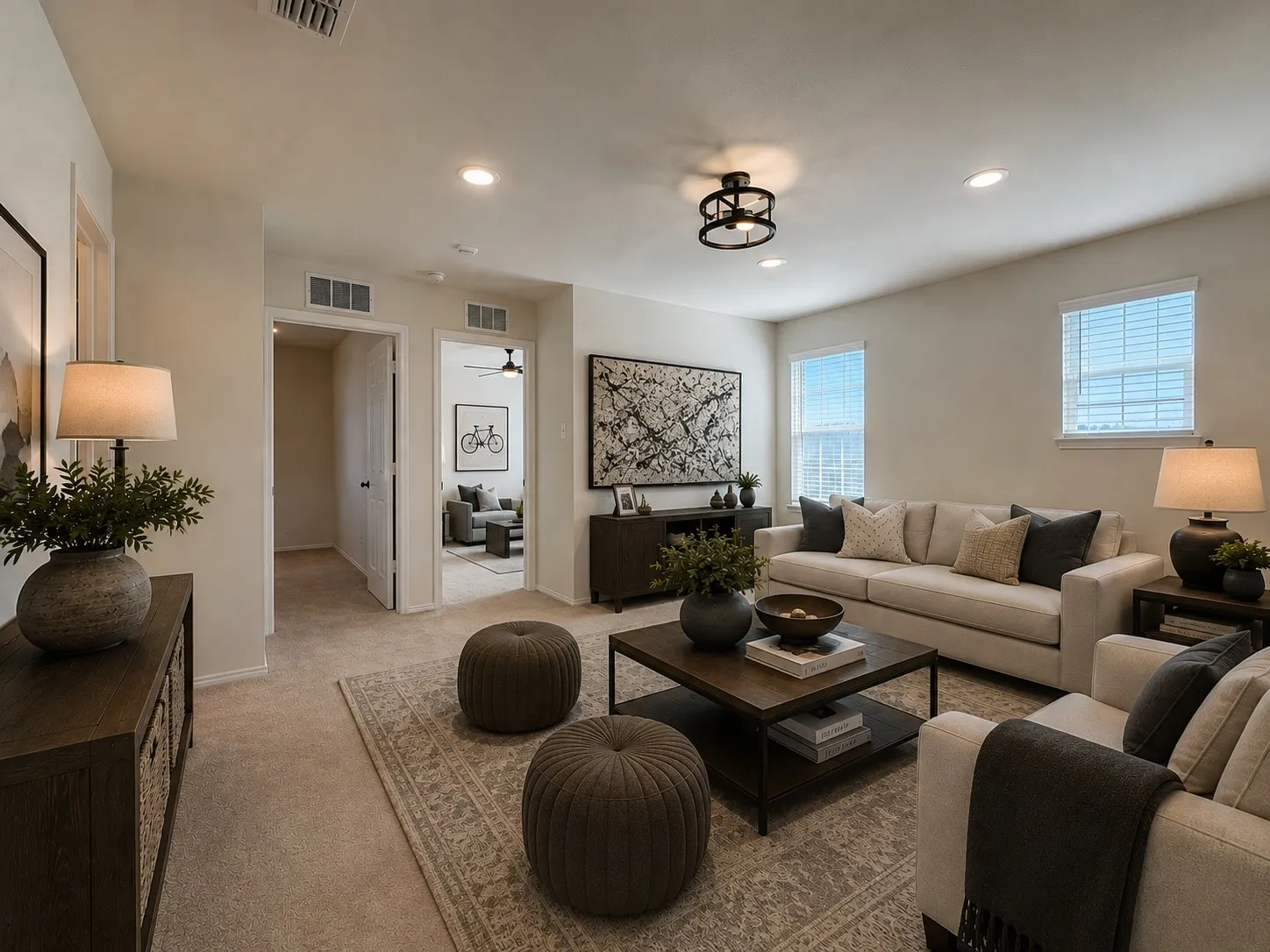 Recessed lighting, a contemporary flush-mount light fixture, and multiple windows provide ample illumination