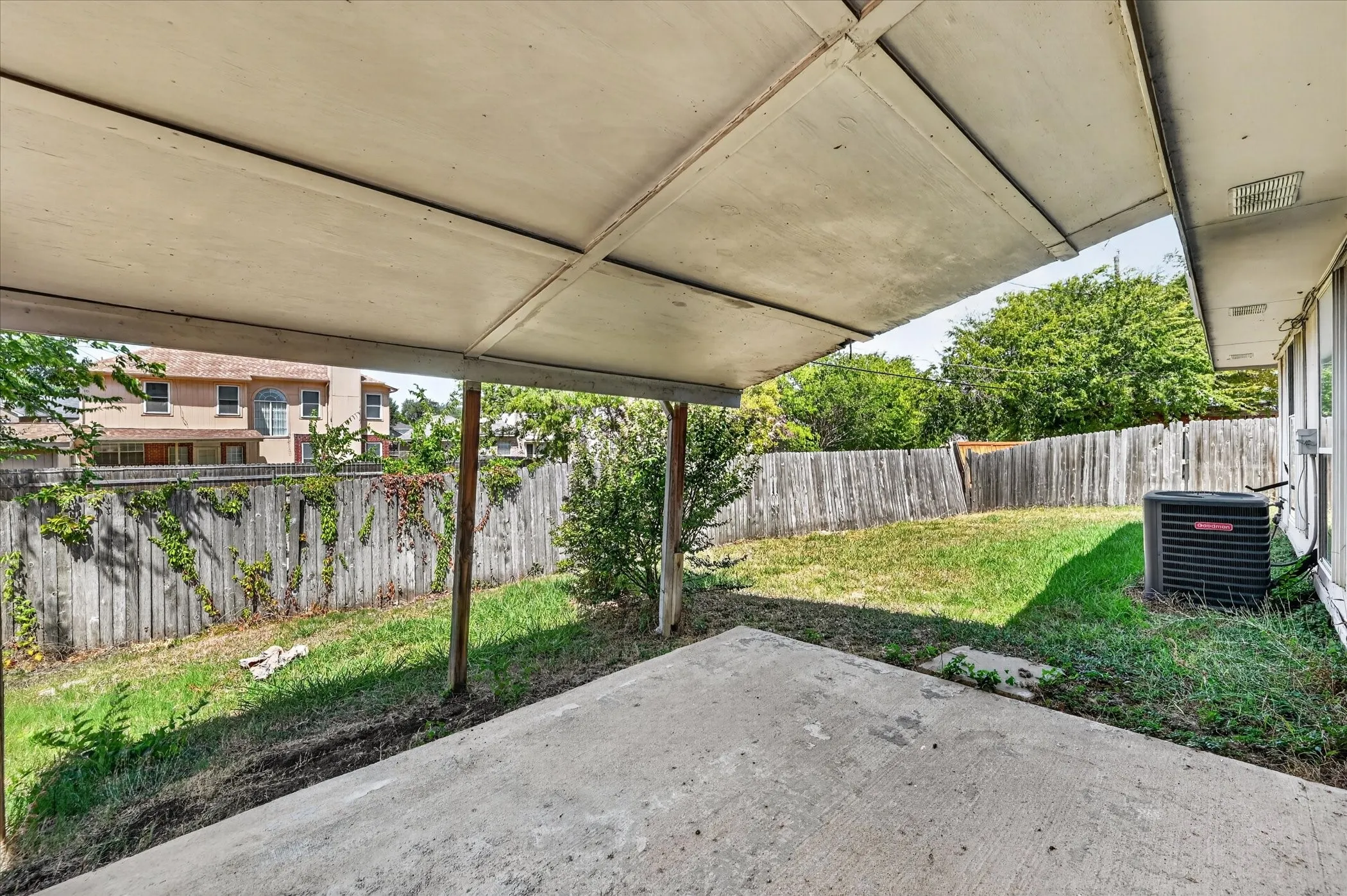 Covered patio featuring a concrete slab and wooden support beams