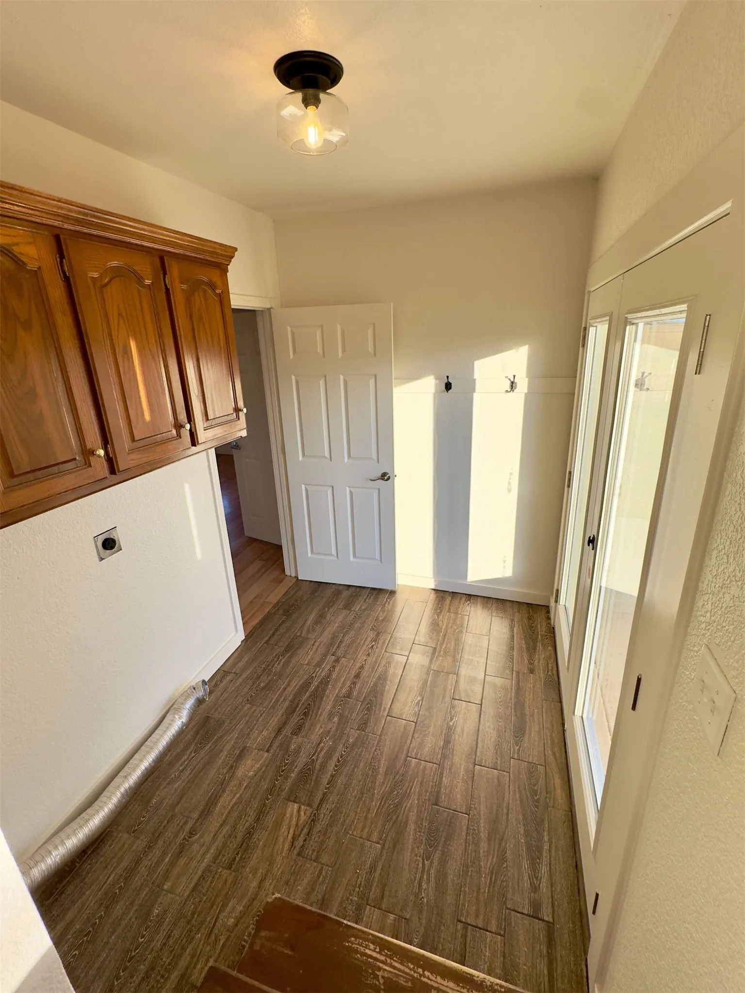 Mudroom area from back door and laundry room.