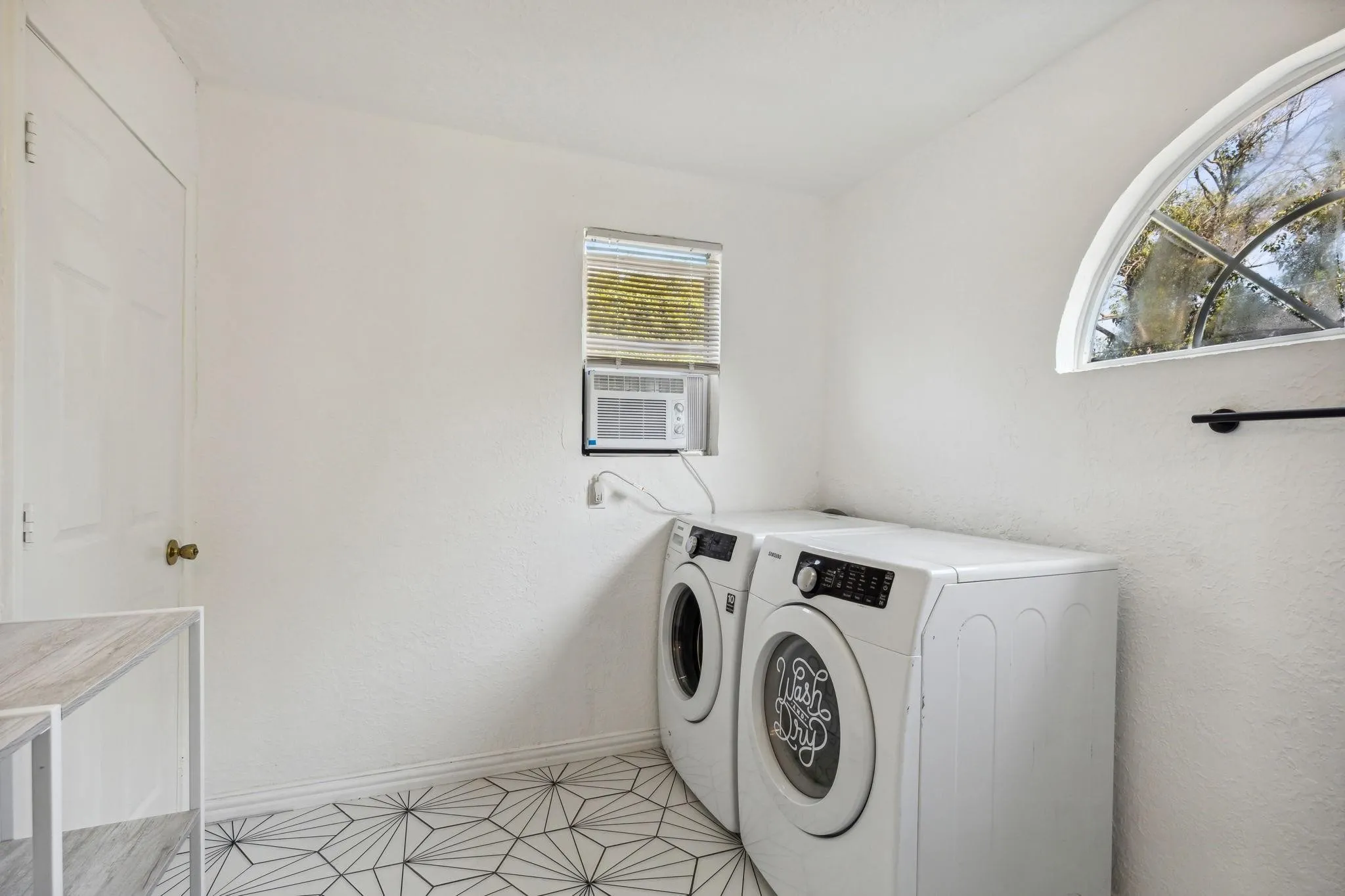 White painted walls with a small rectangular window and an arched window