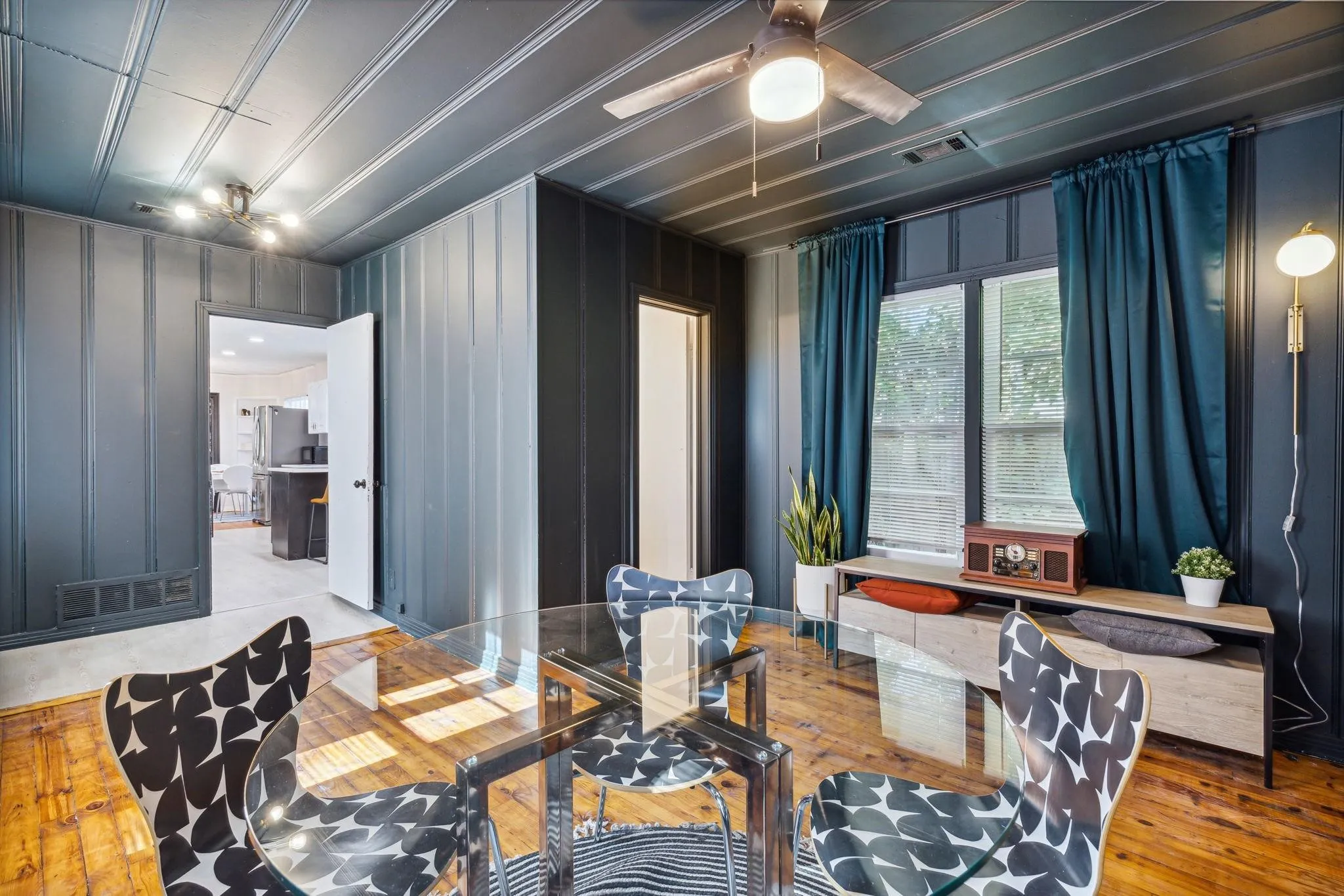 Hardwood-finish flooring throughout, featuring a ceiling fan with integrated lighting