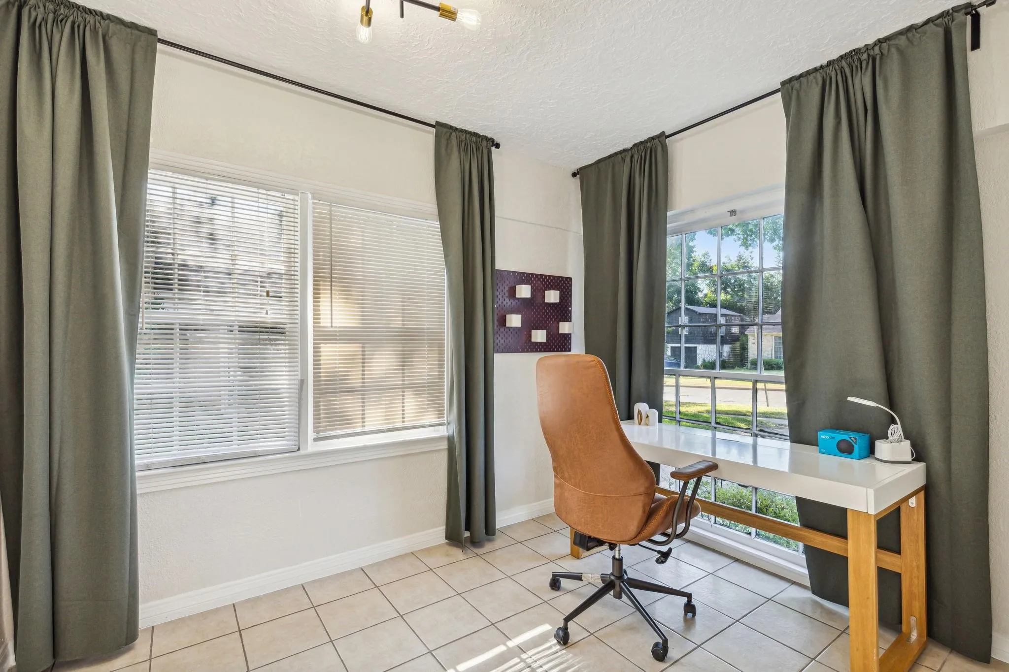 Recessed lighting, tile flooring, and multiple windows with blinds