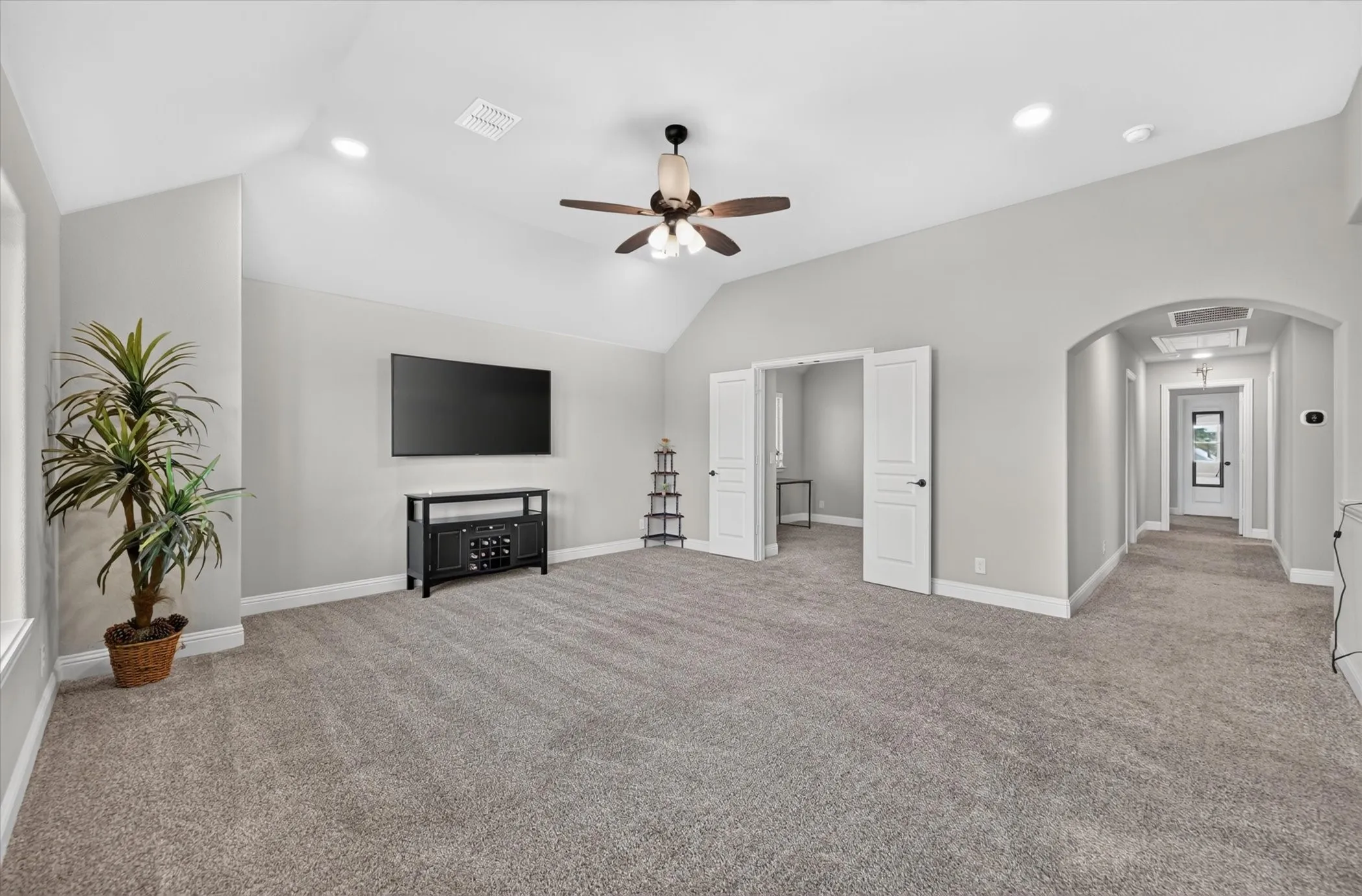 Upstairs Vaulted ceiling with recessed lighting, ceiling fan, and light grey wall finishes