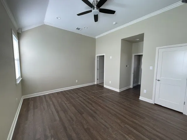 Vaulted ceilings with recessed lighting, wood-finish flooring, and crown molding