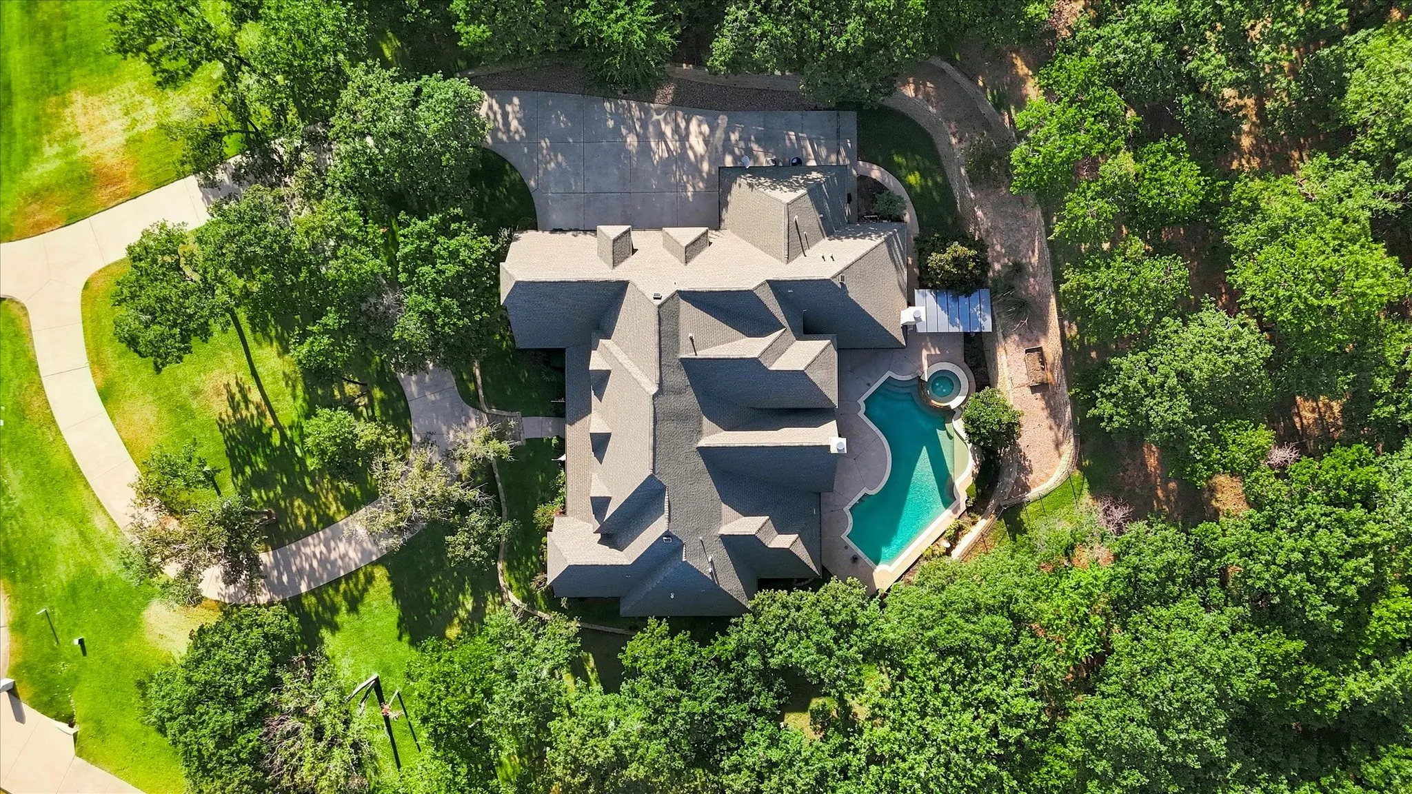 Over 5000 sq feet estate with extensive roofline, integrated swimming pool, and spa