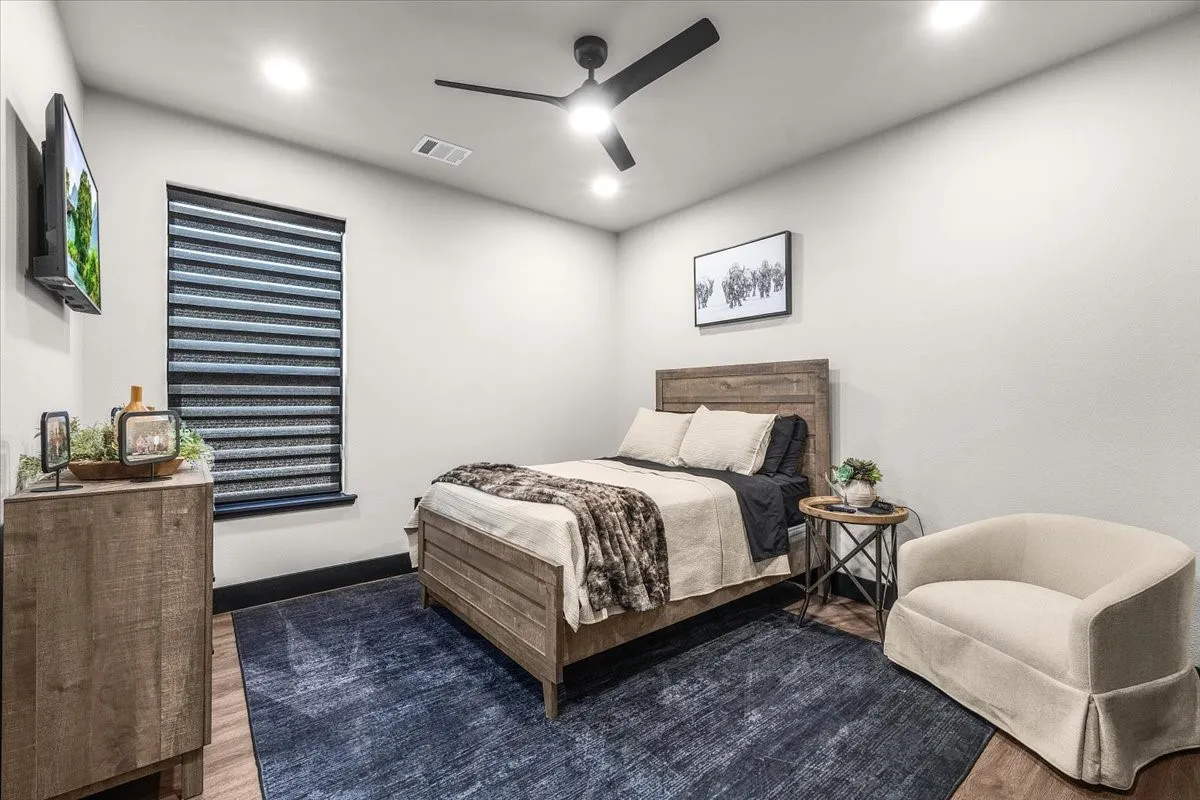 Recessed lighting, wood-finish flooring, and a ceiling fan with integrated lighting