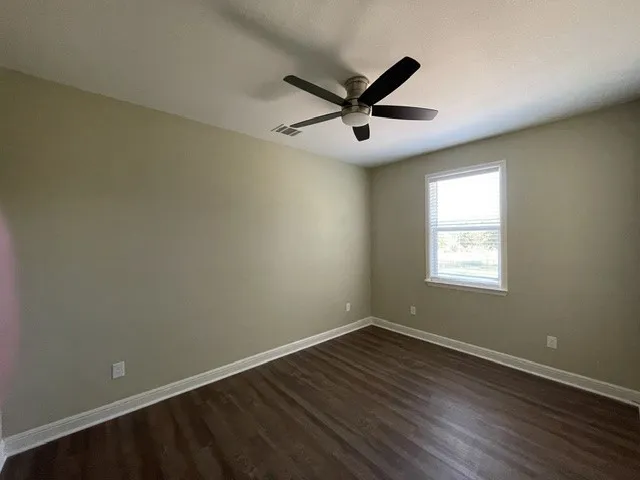 Dark wood-finish flooring with light wall paint