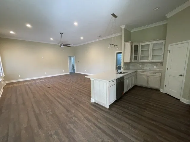 Open concept living space featuring wood-finish flooring, recessed lighting, and a ceiling fan