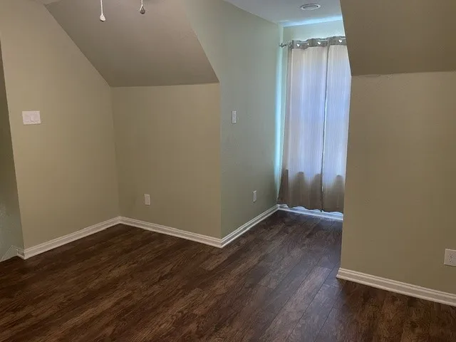Wood-finish flooring, white trim, and light green walls
