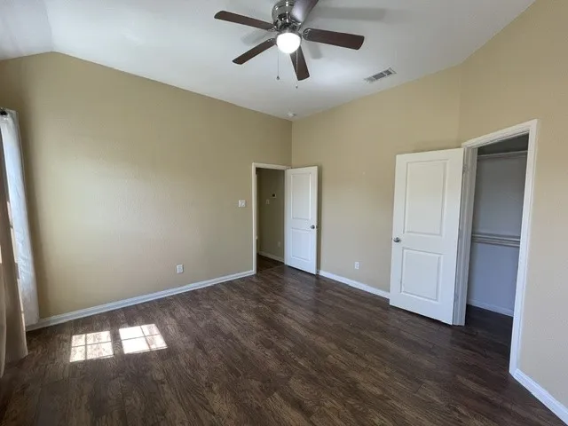  ceiling fan, wood-finish flooring, and recessed closets with solid panel doors