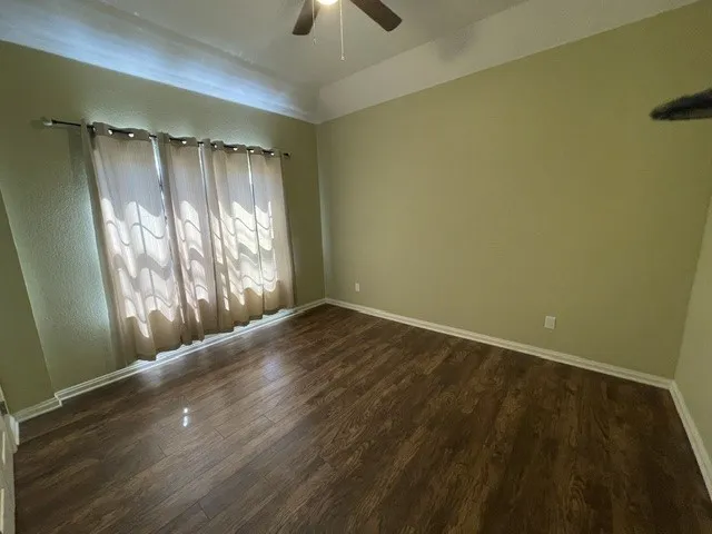 Recessed ceiling, wood-finish flooring, and a ceiling fan