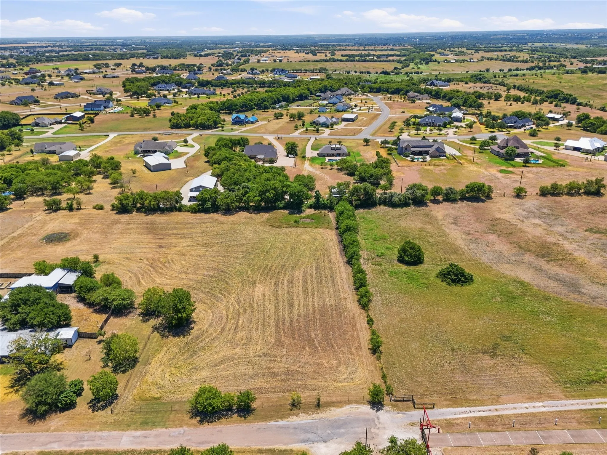 Expansive undeveloped lot featuring varied topography and perimeter tree line