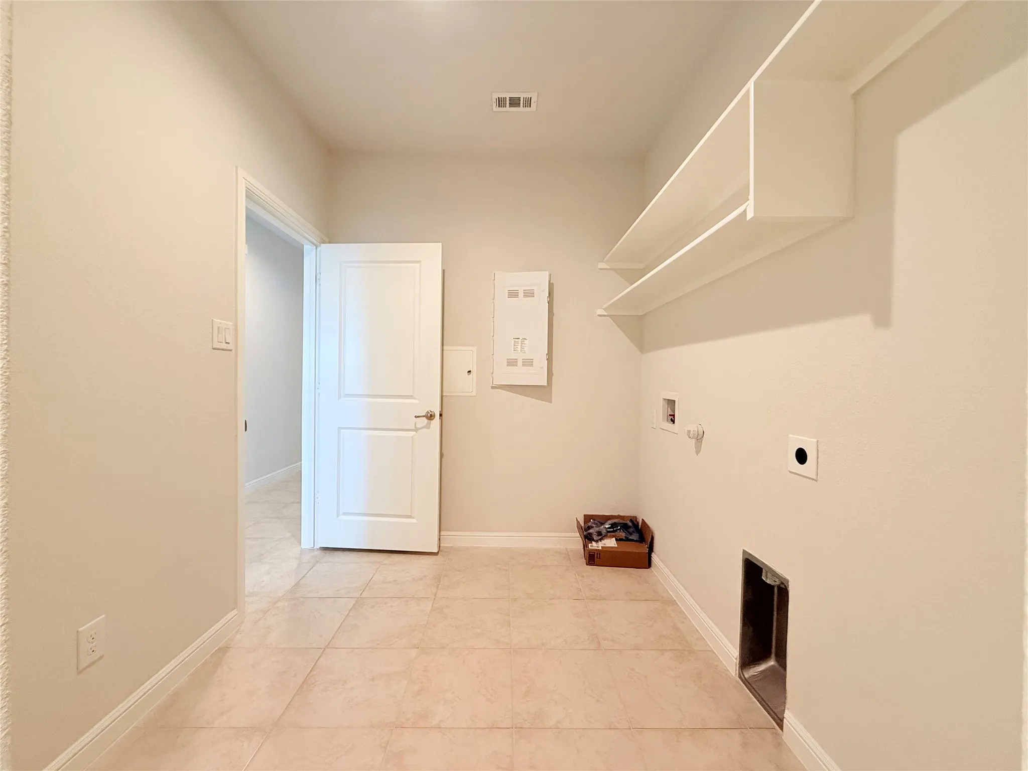 Recessed lighting illuminates neutral-toned walls and tile flooring