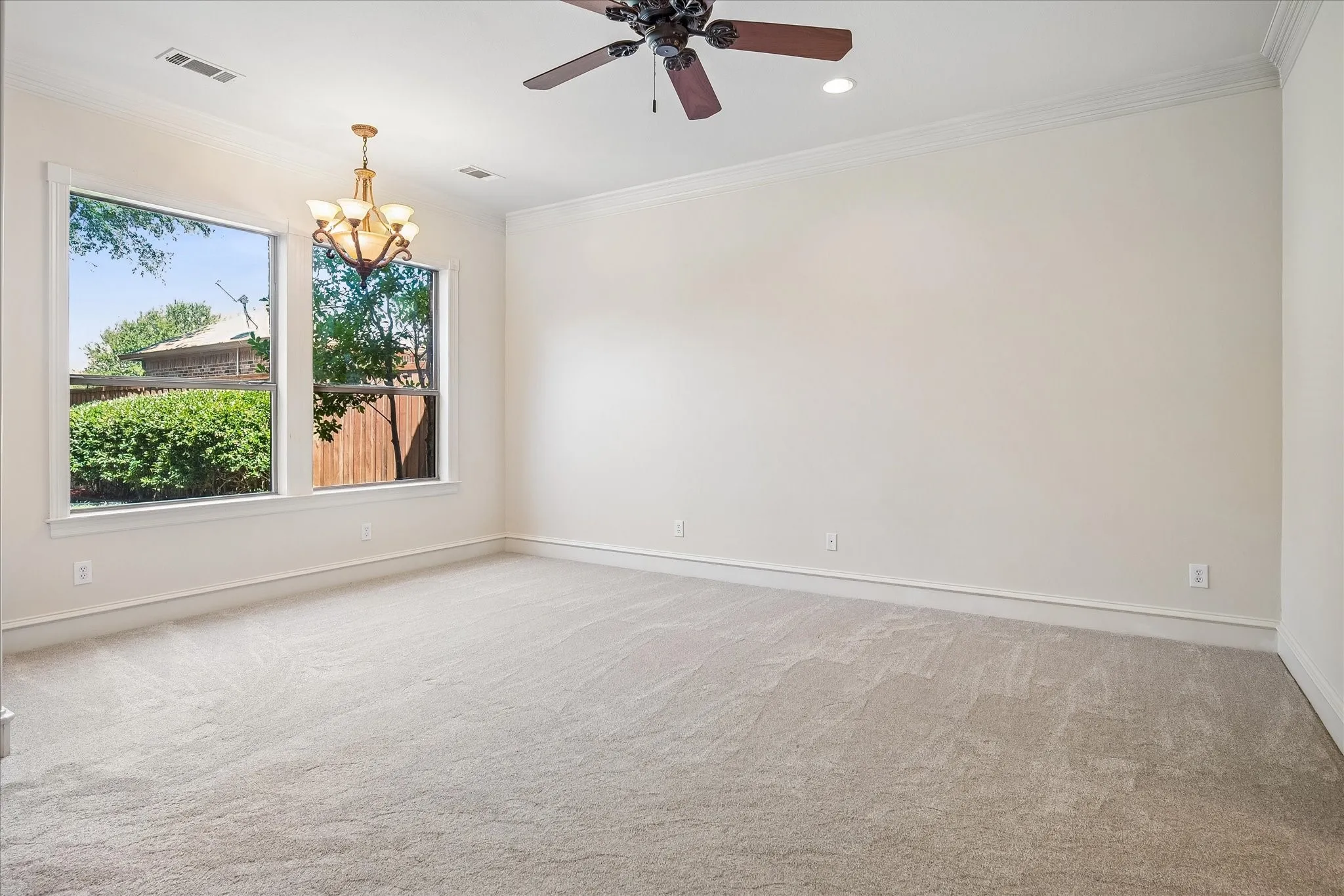 Stunning and sunny primary bedroom with two large windows