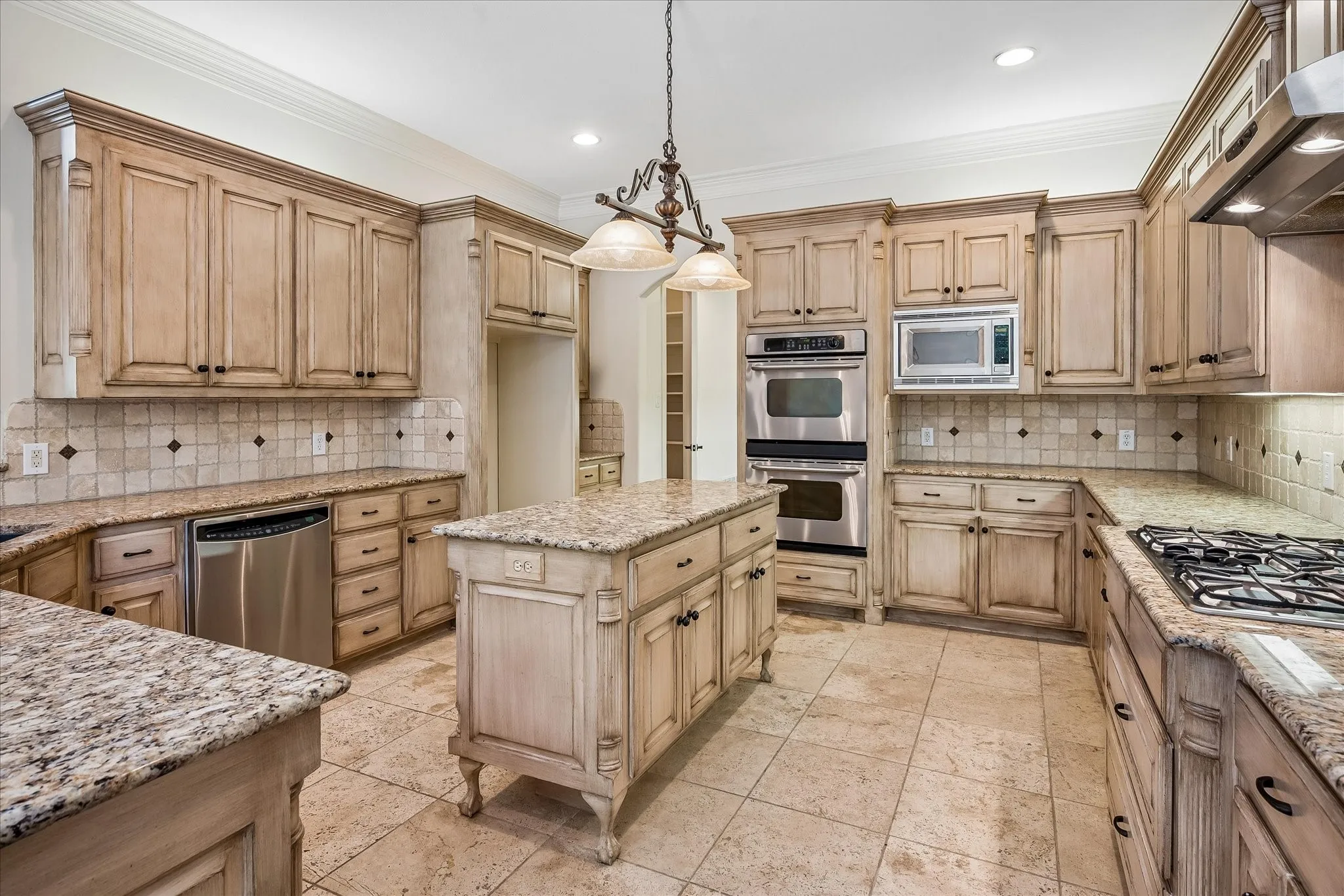 Kitchen with beautiful granite countertops and travertine tile floor