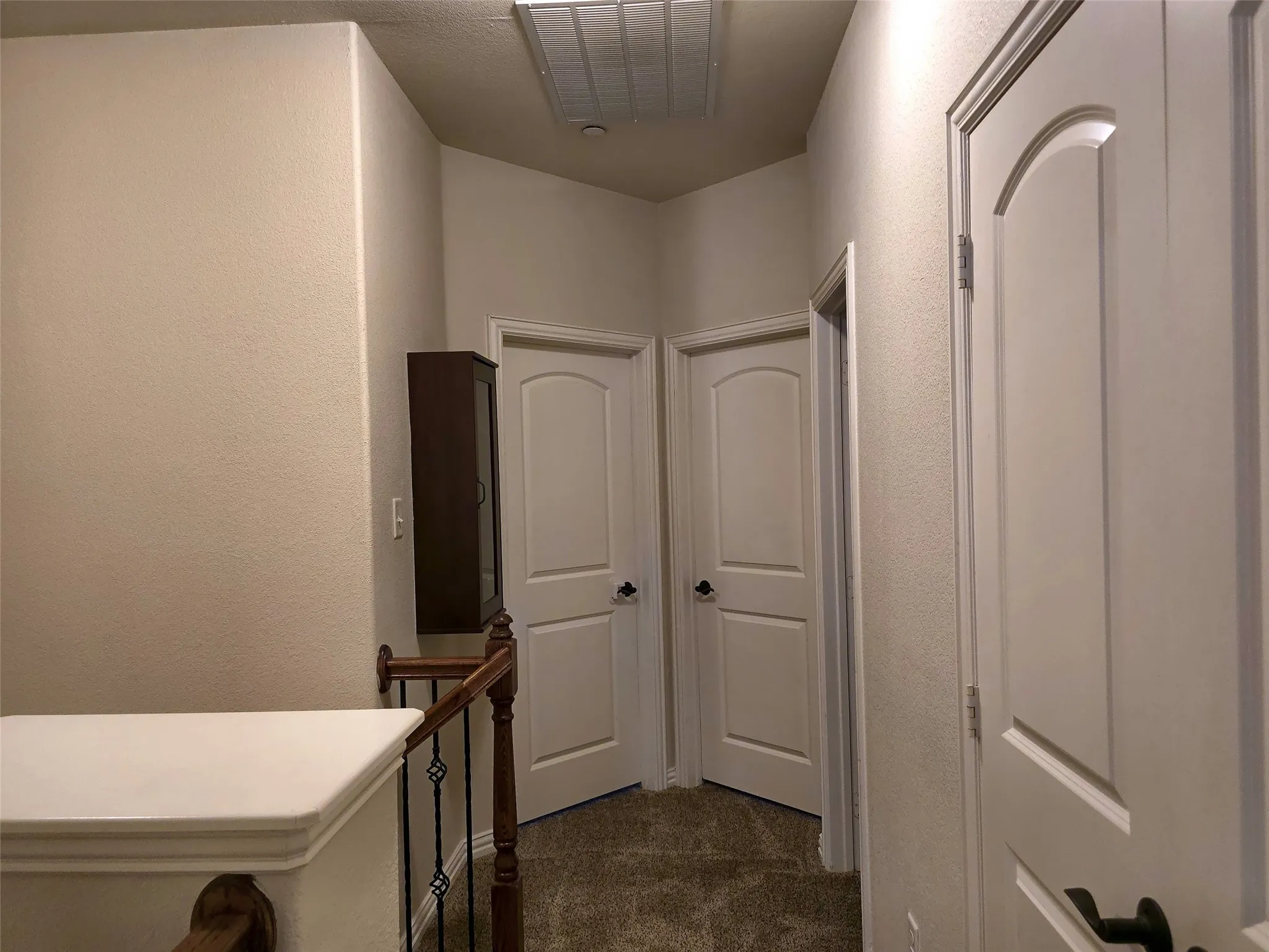 Hallway with neutral wall tones and a textured finish