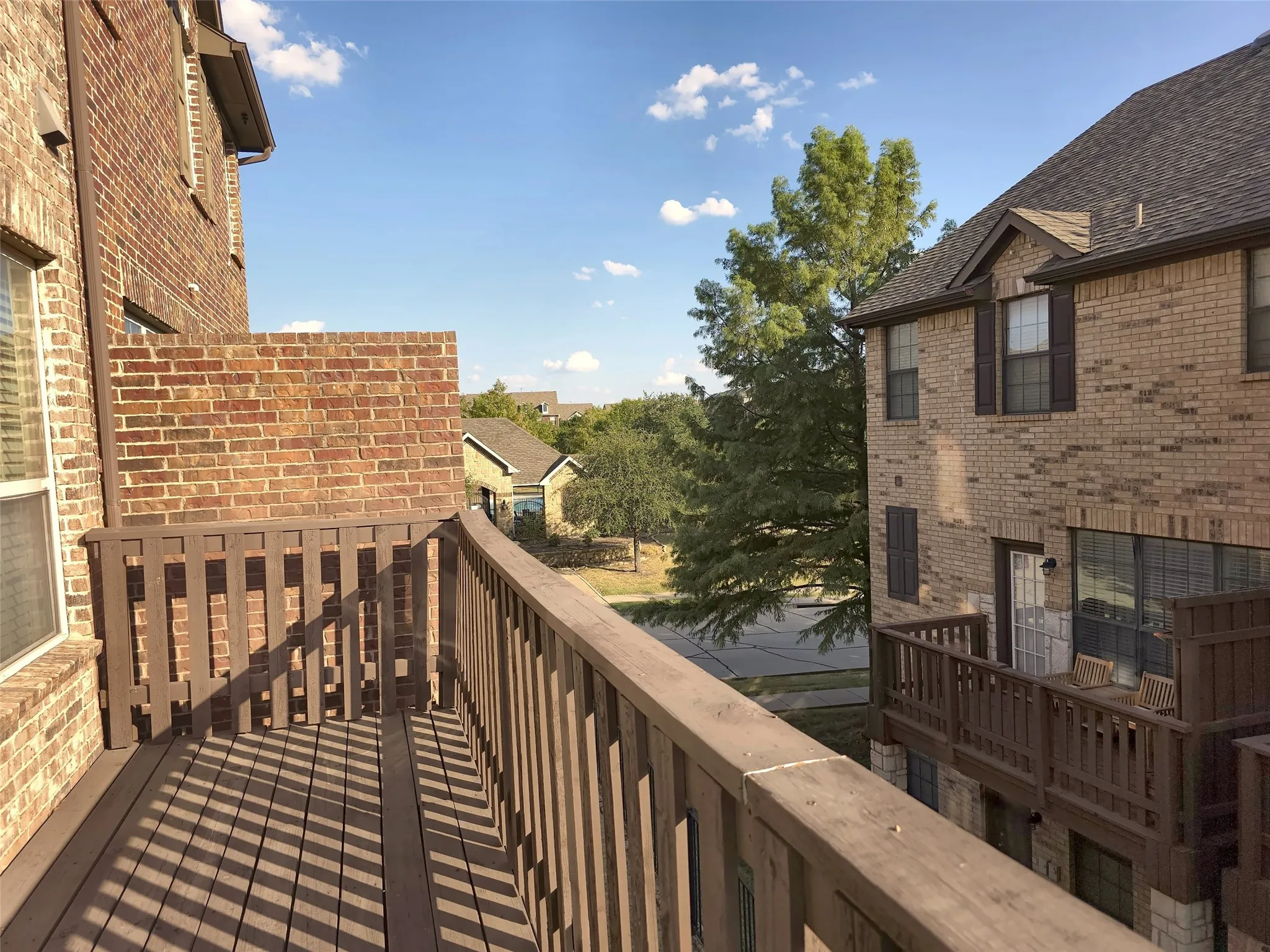 Exterior balcony with composite decking and wood railing