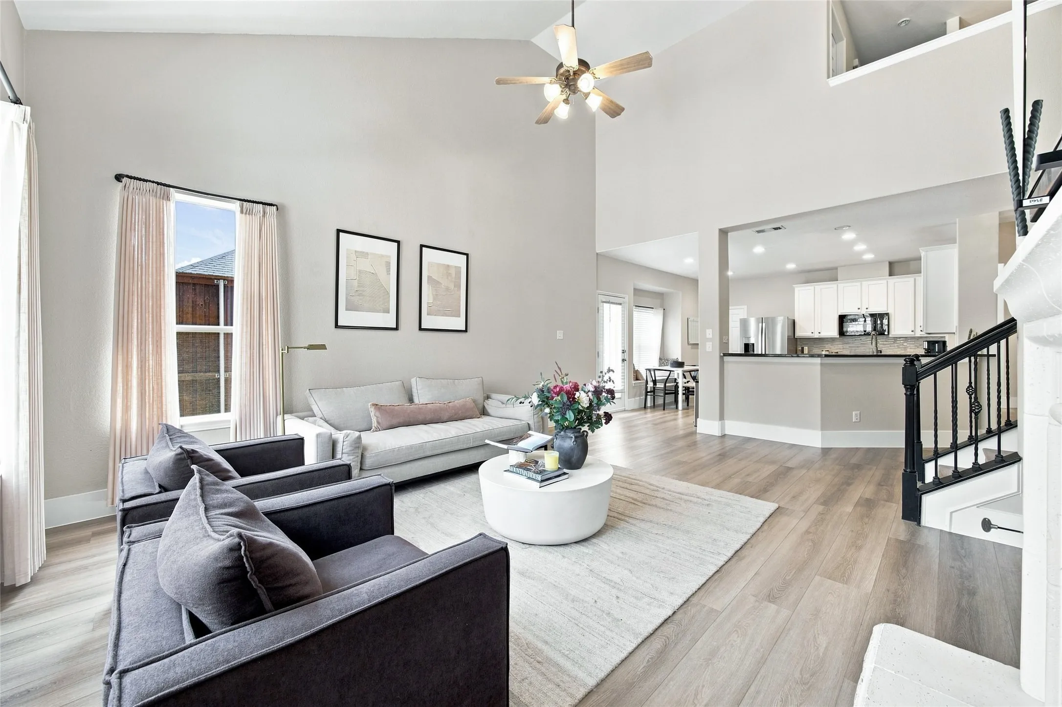 Soaring ceiling, with ample natural light pouring into the living room brightening the open concept layout