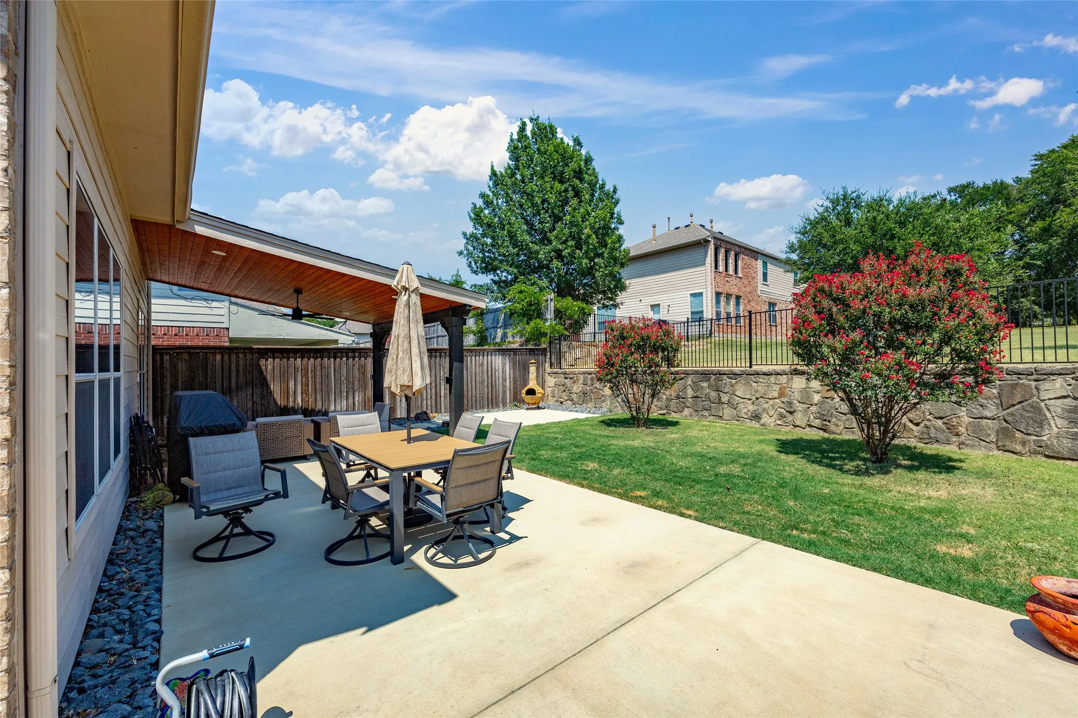 Plenty of space in this back yard to enjoy your time relaxing under the Covered patio surrounded by the lush landscaping