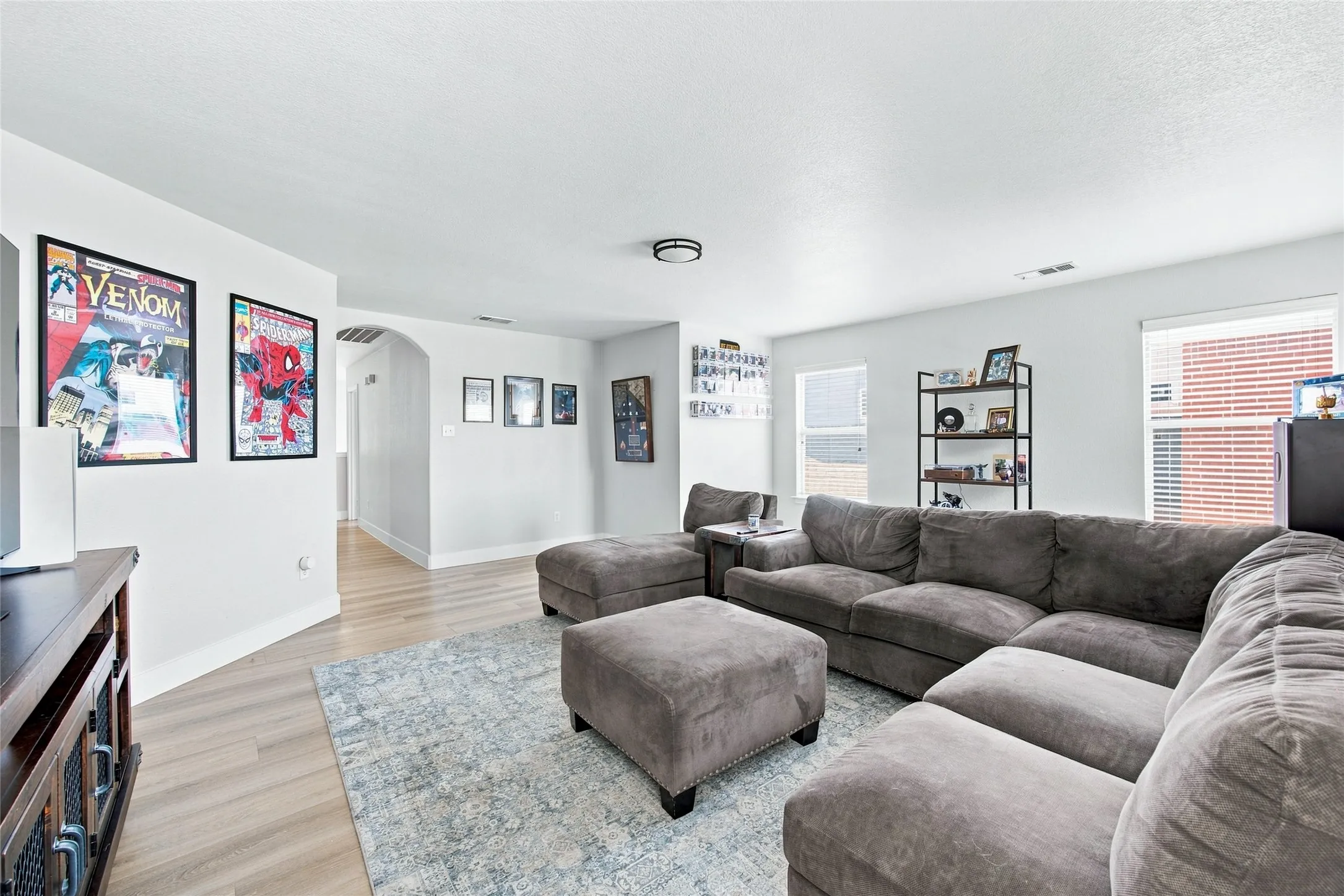 Spacious gameroom found on the second floor has plenty of room for all your family needs. Nice arched doorway, and multiple windows with blinds allowing tons of natural light to flow directly into the room.
