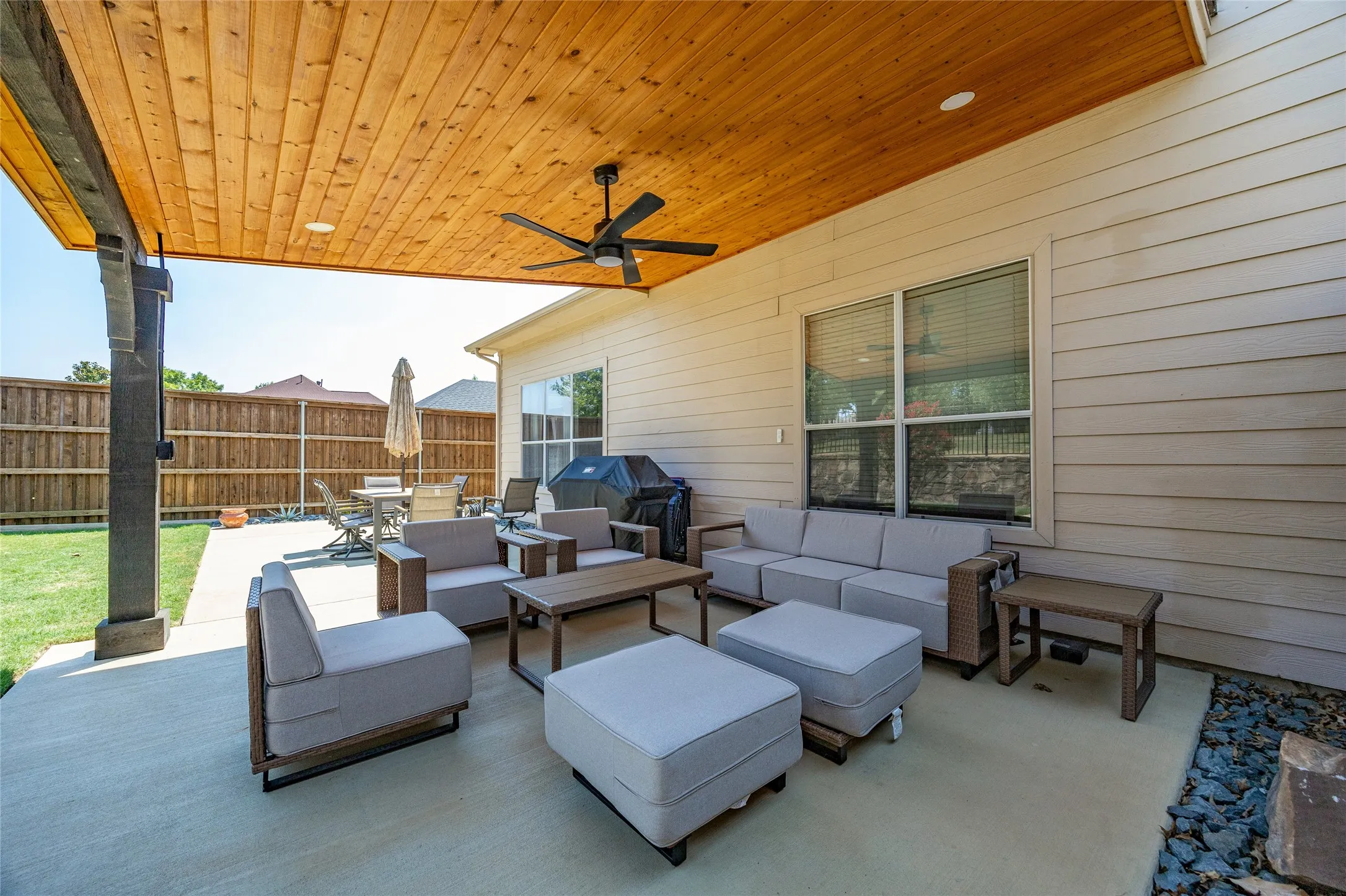 Great place to relax on your weekends or for morning coffe in this Inviting Covered patio featuring a wood-panel ceiling, ceiling fan, recessed lighting, and concrete flooring.  Perfect space to entertain guests and family.