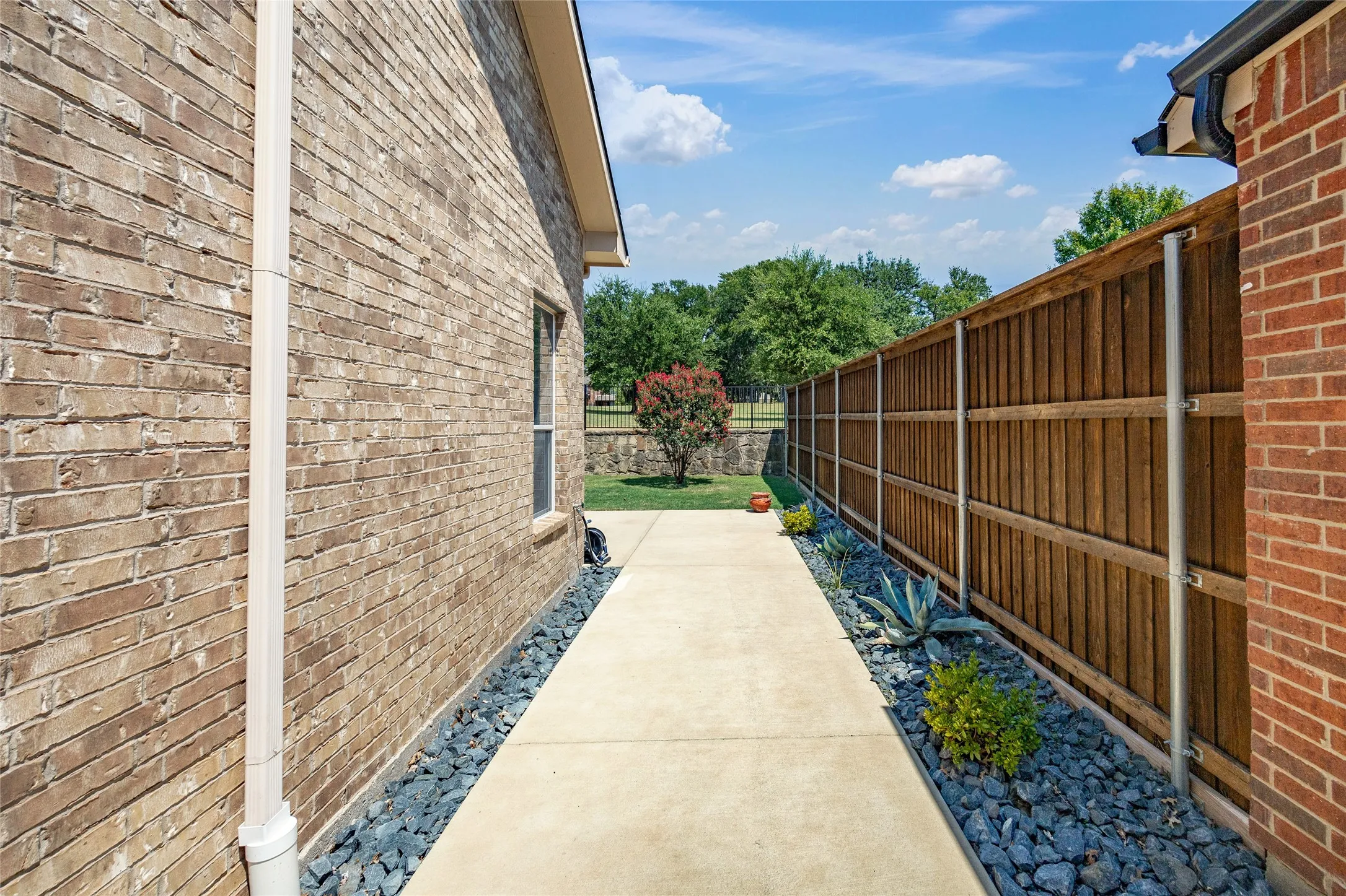 Inviting walkway found directly outside kitchen back door area leads you to the backyard.