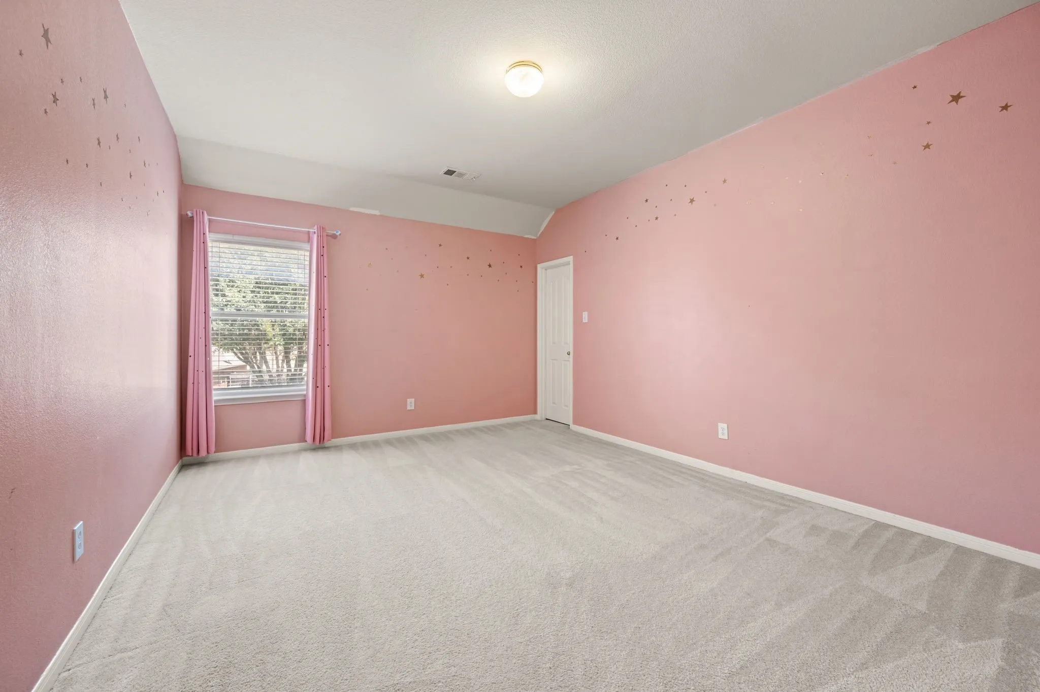 Recessed window with blinds, wall-to-wall carpeting, and a flush mount ceiling light fixture