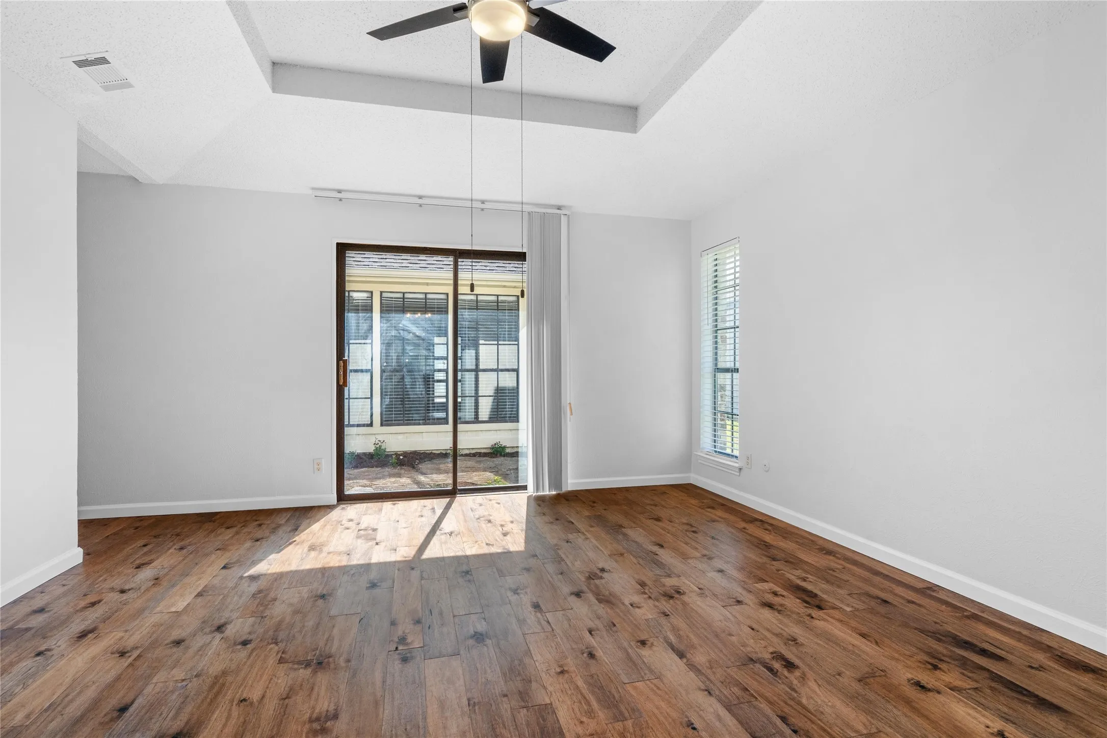 Primary Bedroom with sliding door to patio.