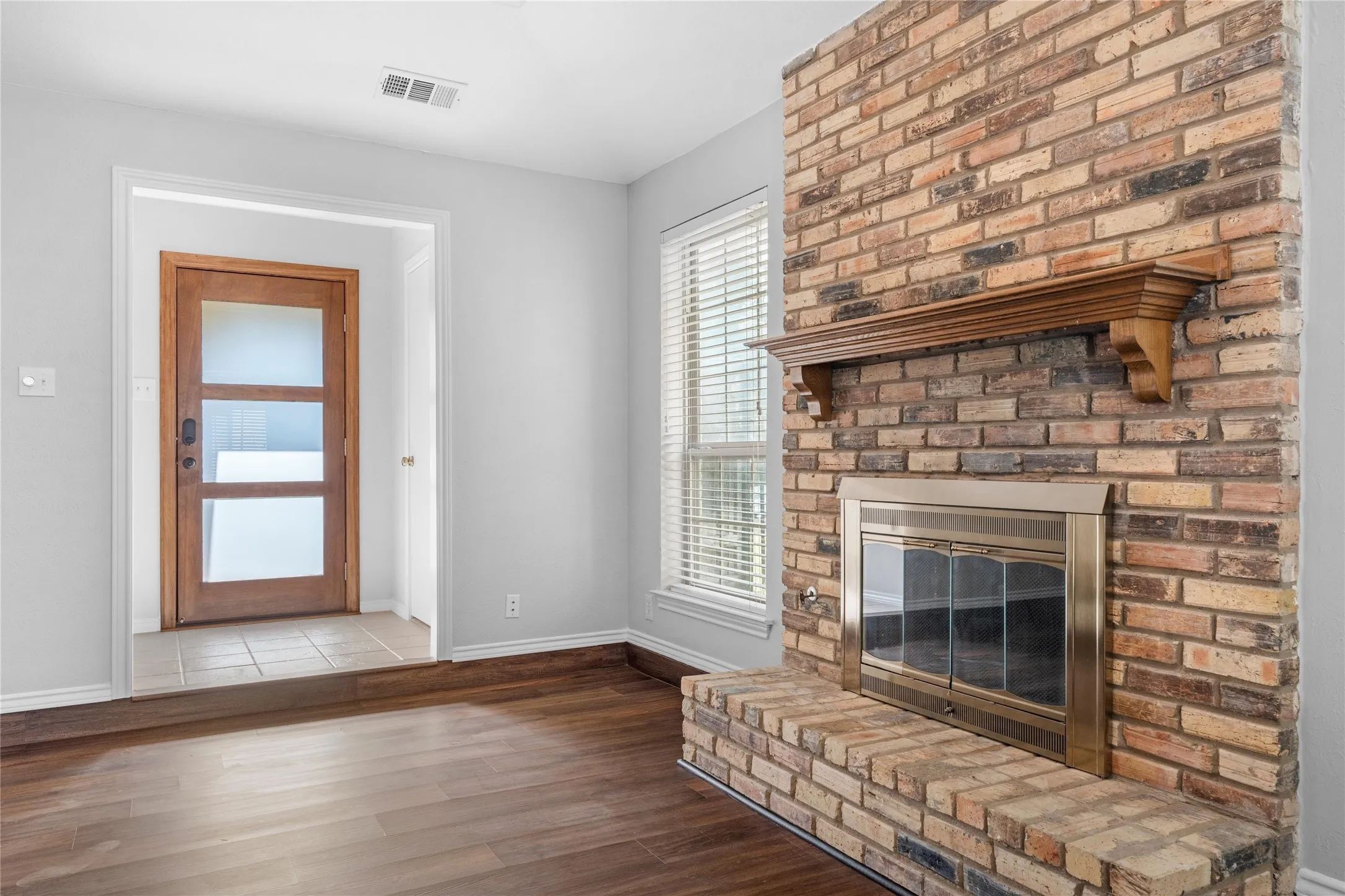 Living room with wood burning fireplace with gas starter.
