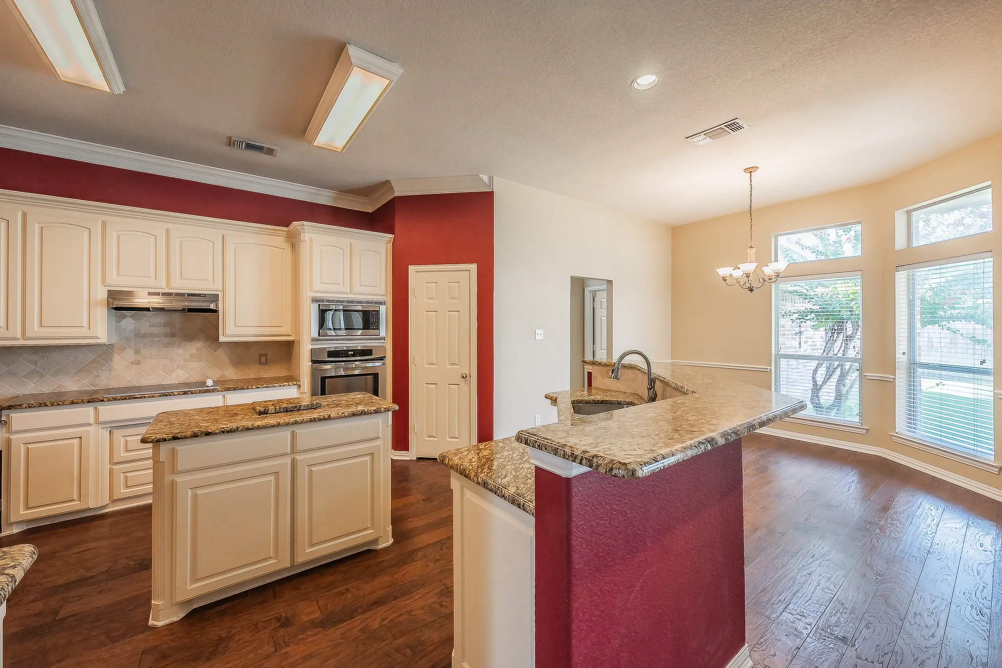 Kitchen featuring stainless steel appliances, a center island, and granite countertops