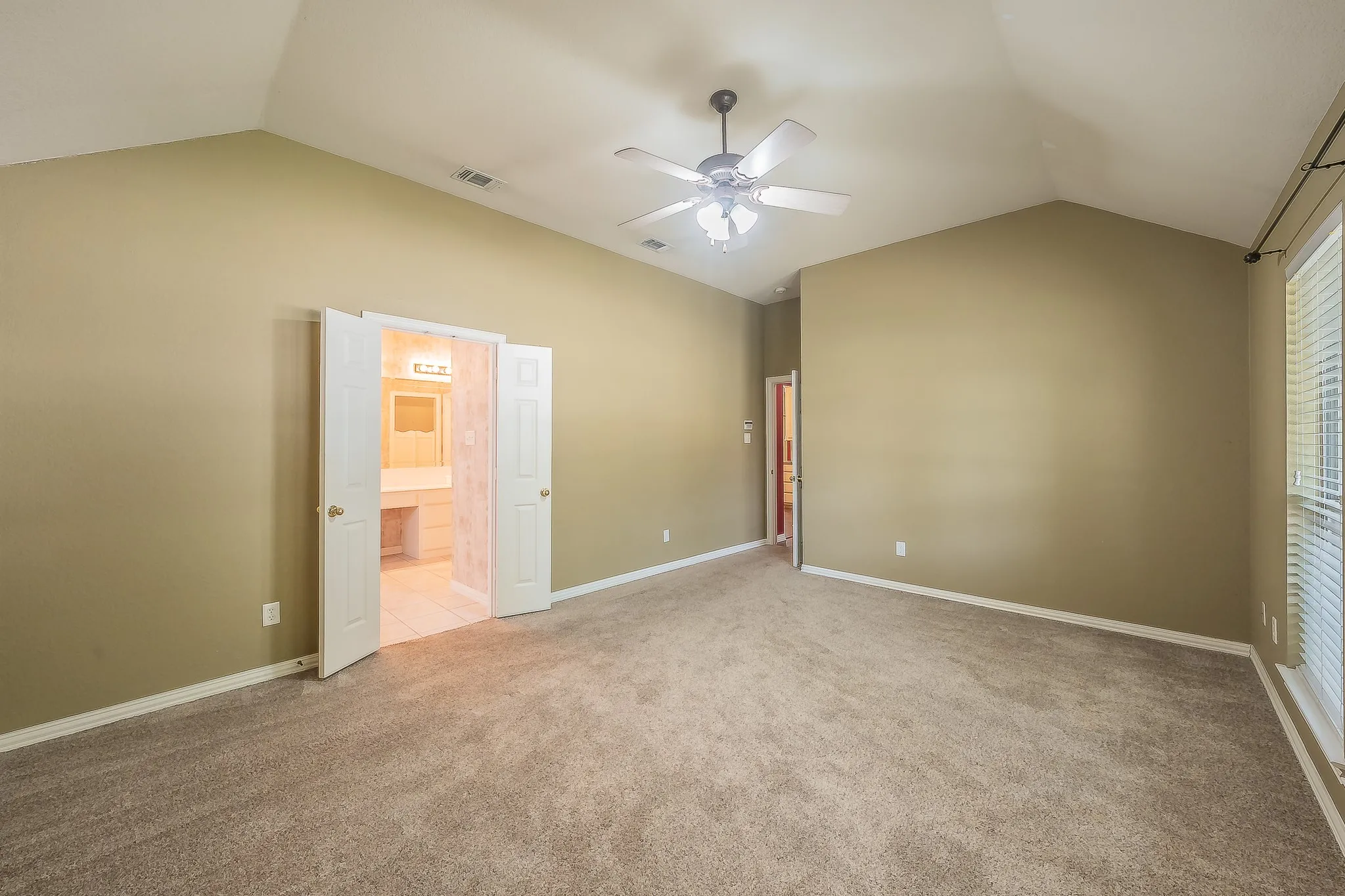 Vaulted ceilings and carpeted flooring