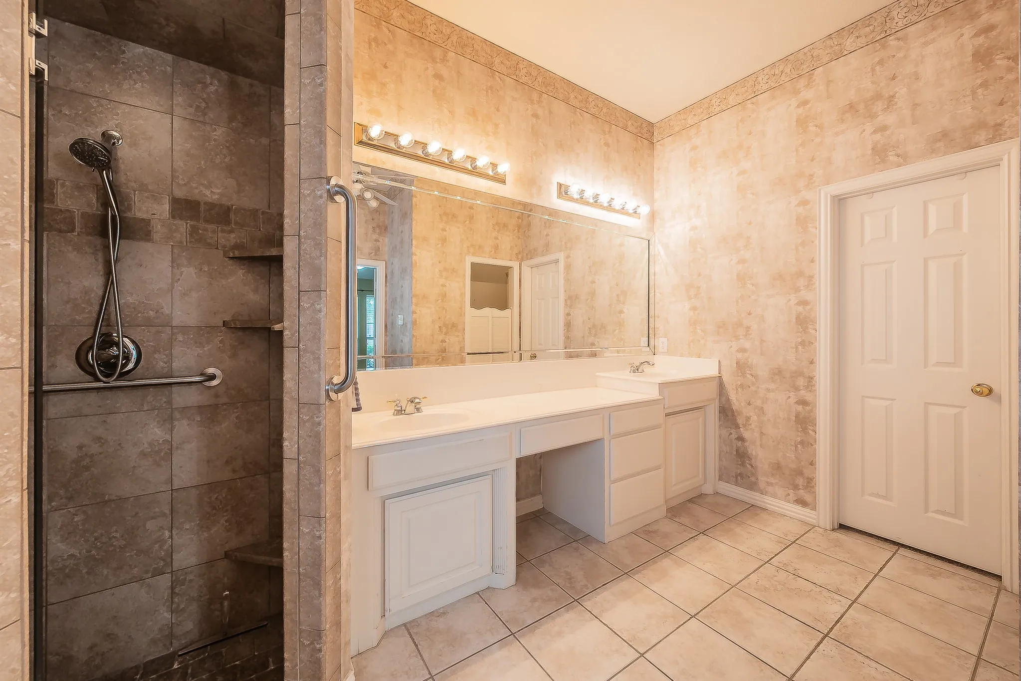 Tiled shower enclosure with built-in shelving and grab bar